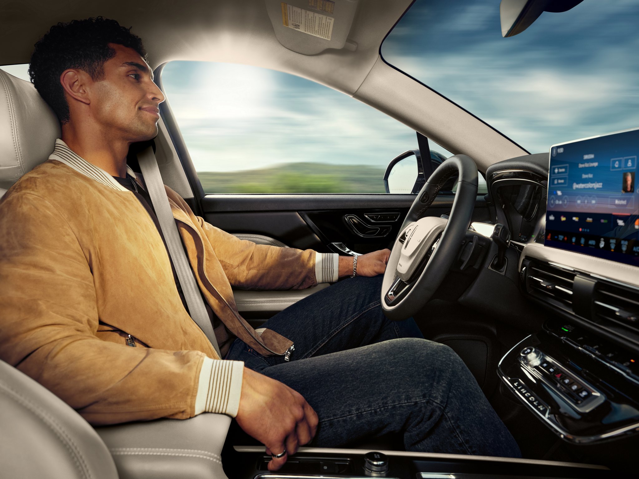 A driver enjoys using Lincoln BlueCruise hands-free restricted access divided highway driving