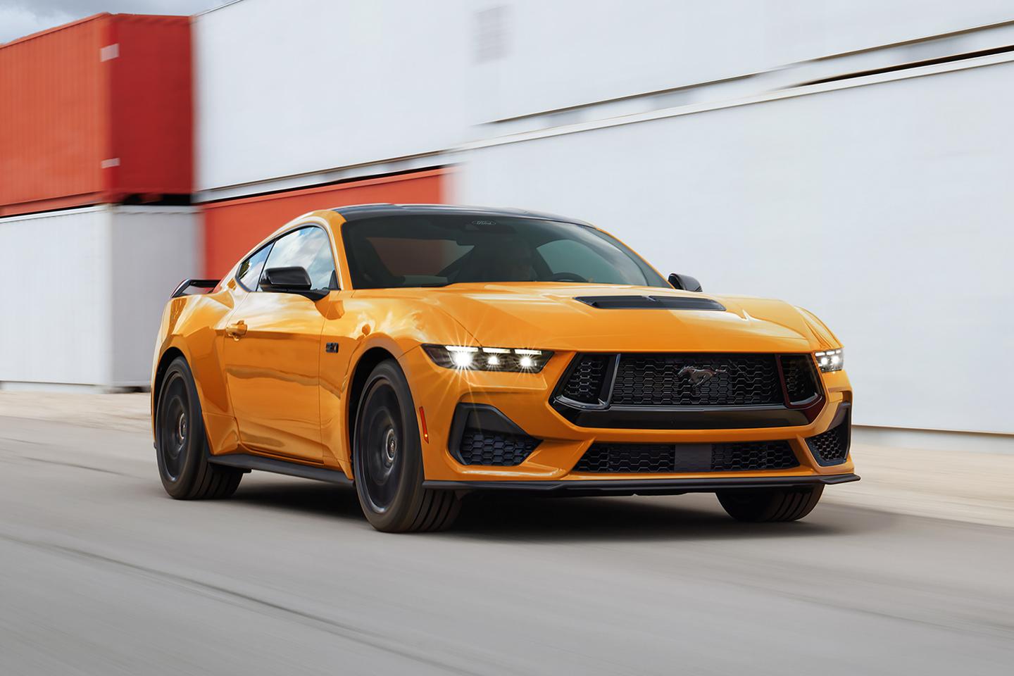 2026 Ford Mustang® GT model in Orange Fury Metallic Tri-coat being driven on a closed course