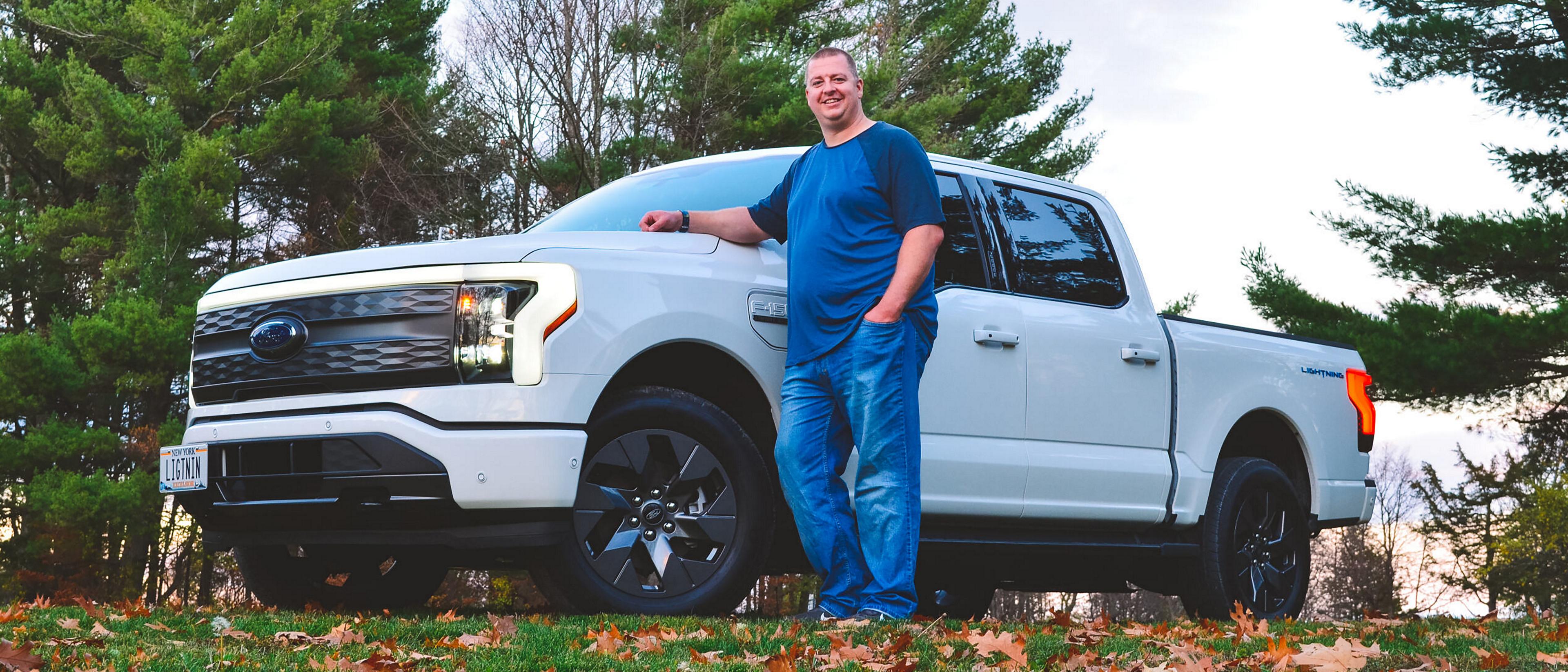 Man standing to the side of his Ford F-150 Lightning