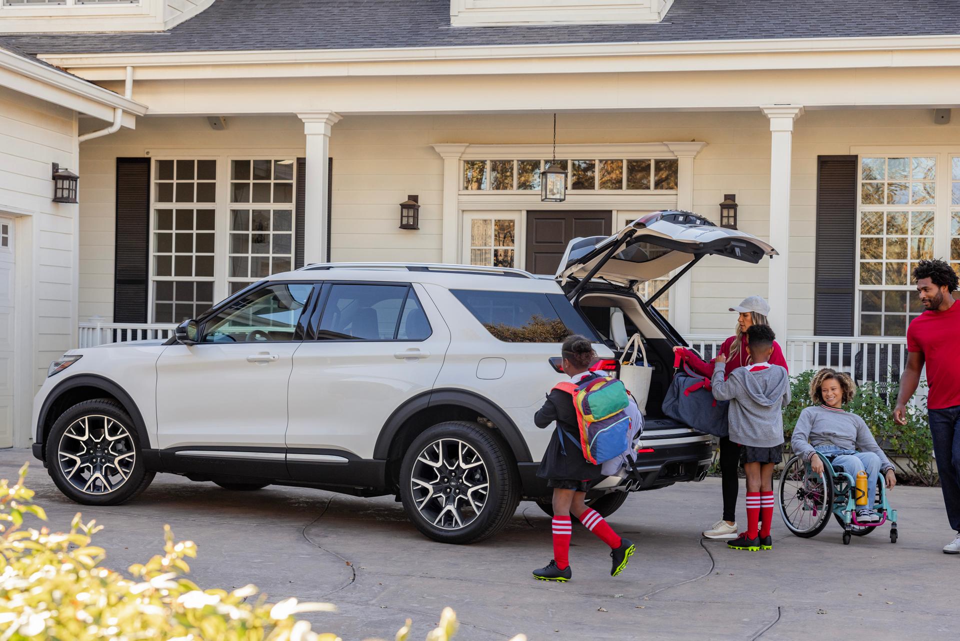A family loads items into the open liftgate of their Ford Explorer® SUV