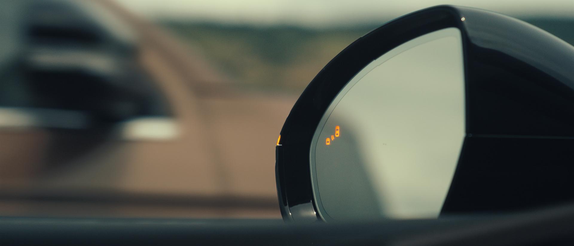 The driver's sideview mirror of a 2026 Lincoln Nautilus® SUV indicates that a vehicle is in its blind spot