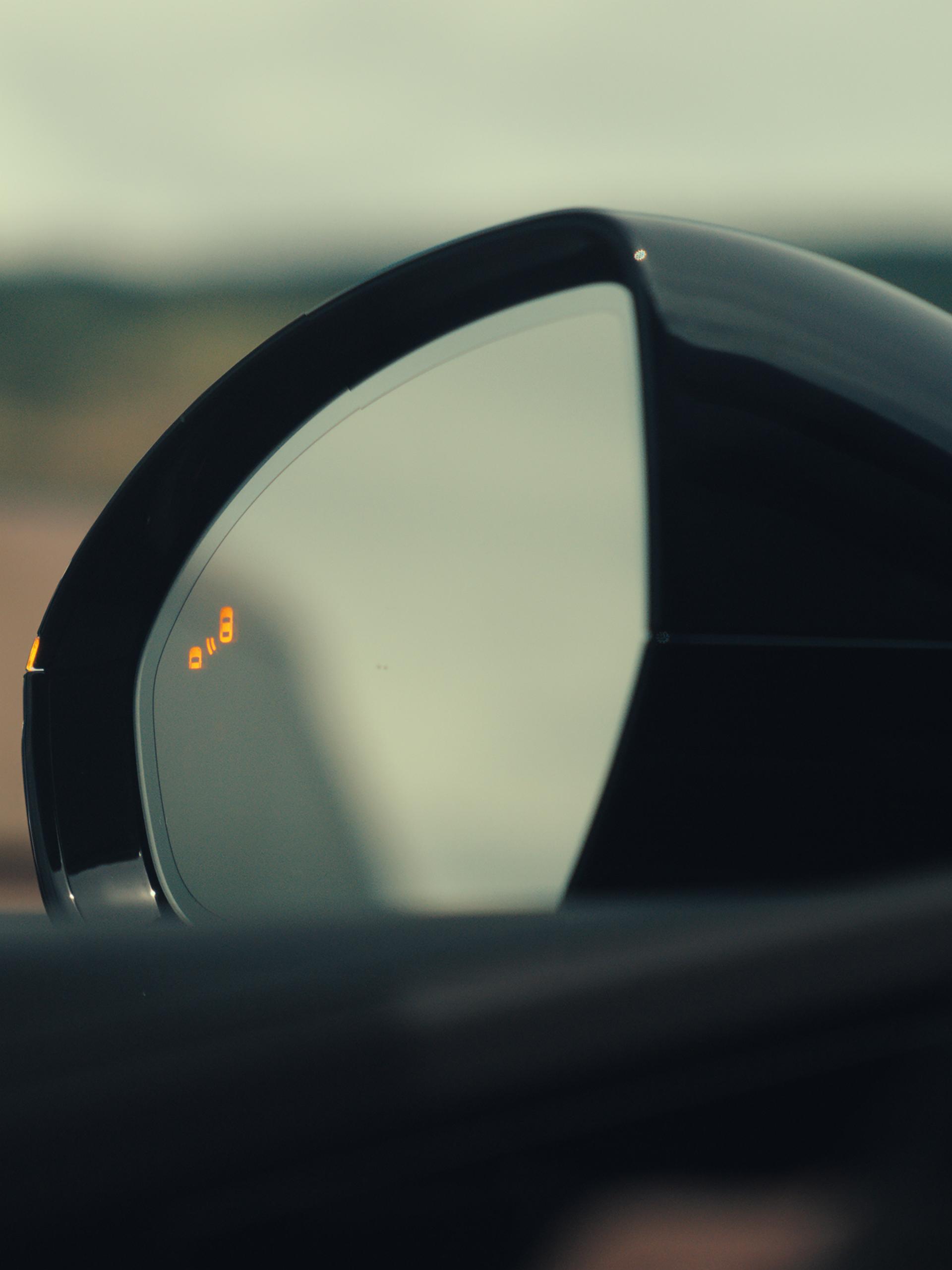The driver's sideview mirror of a 2026 Lincoln Nautilus® SUV indicates that a vehicle is in its blind spot
