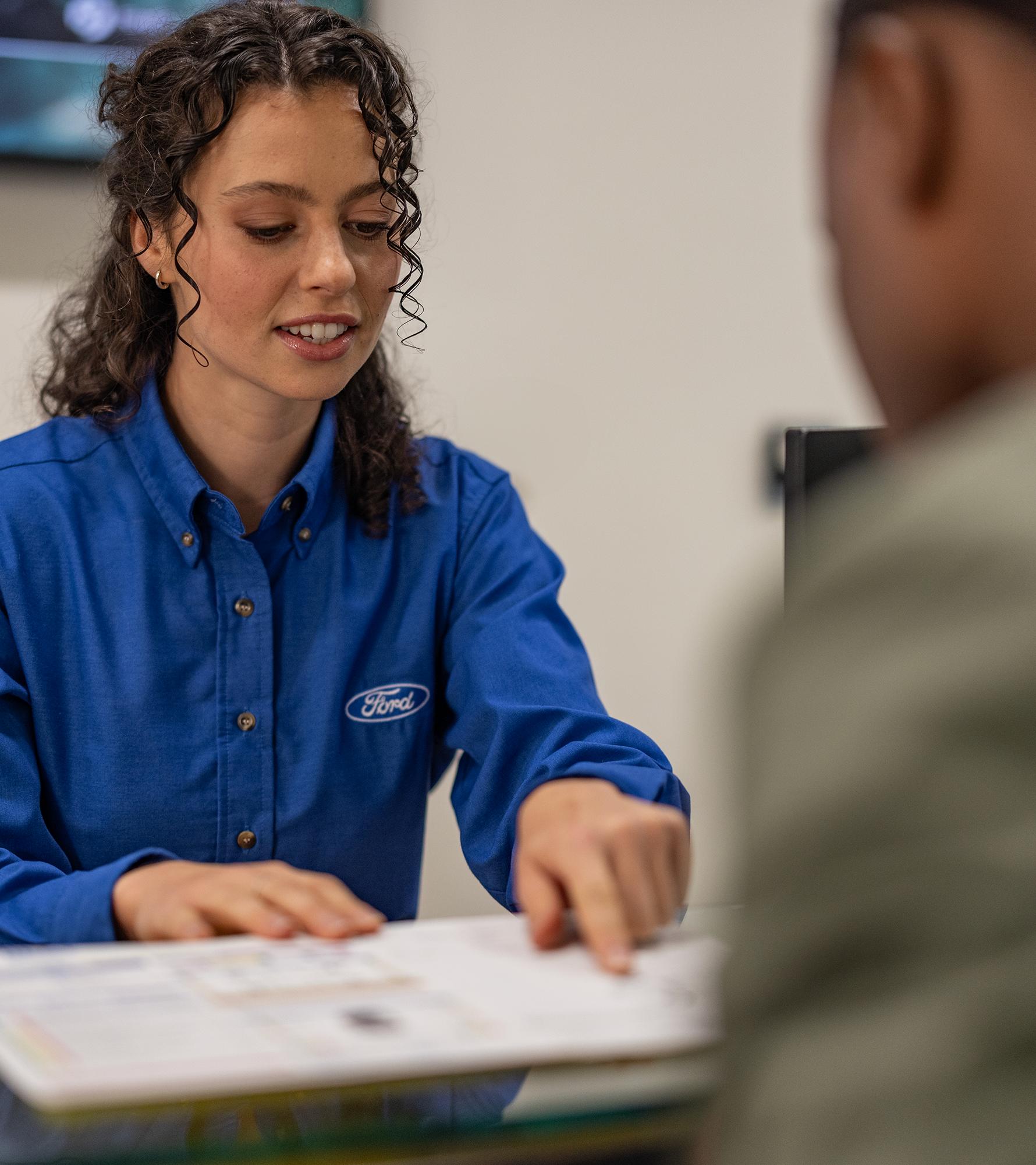 A Ford representative helps a customer