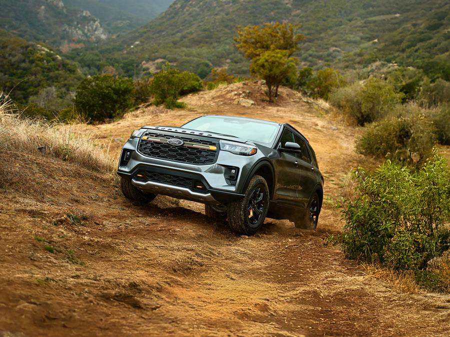 A 2026 Ford Explorer® Tremor® SUV climbing a muddy hill