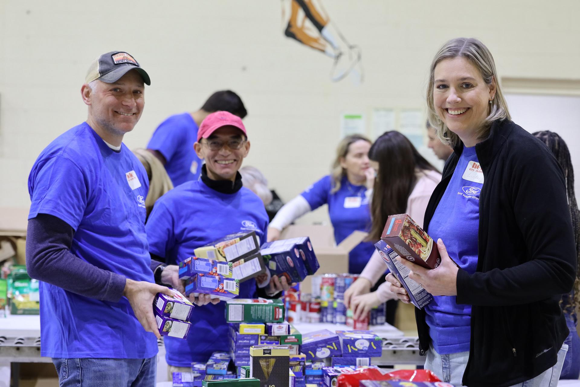 Ford volunteers sort donated goods at a food bank