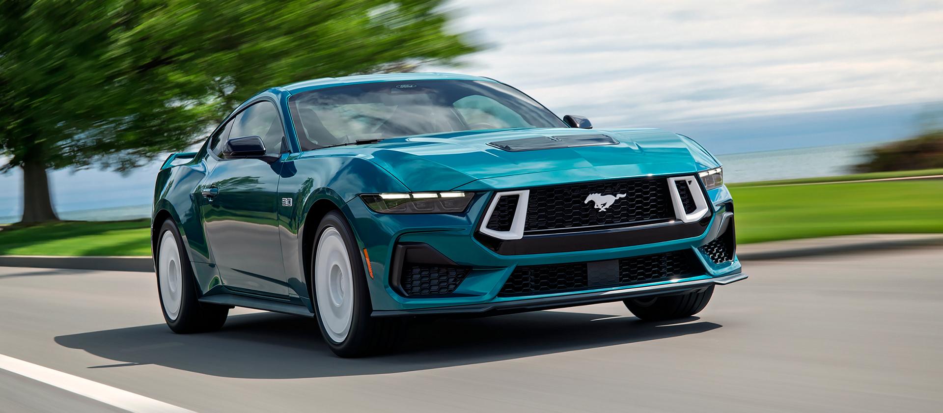 A 2026 Ford Mustang® GT Premium Fastback with the available FX Package being driven near a lake