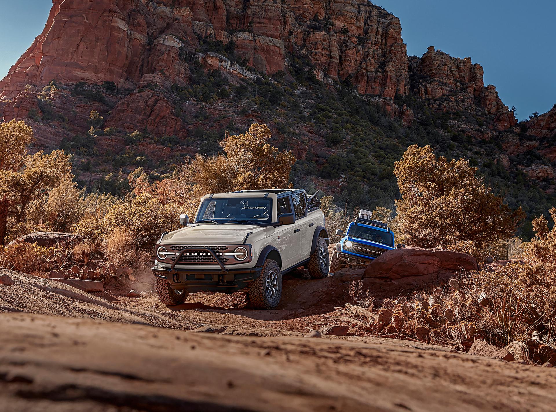 A line of 2026 Ford Bronco® SUVs parked next to each other on a mud flat