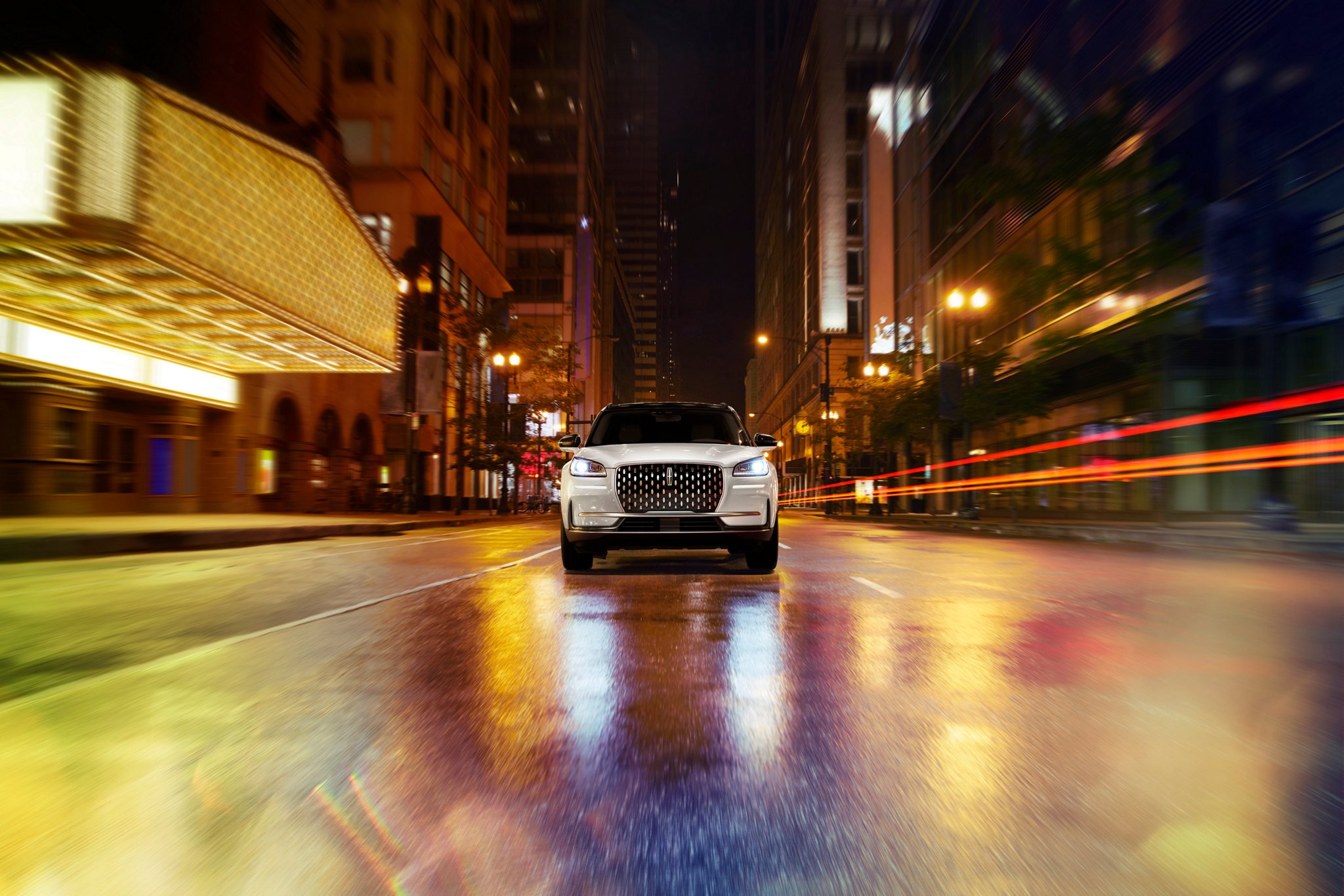 Environmental neon light bounces off the grille of a 2026 Lincoln Corsair® Reserve SUV
