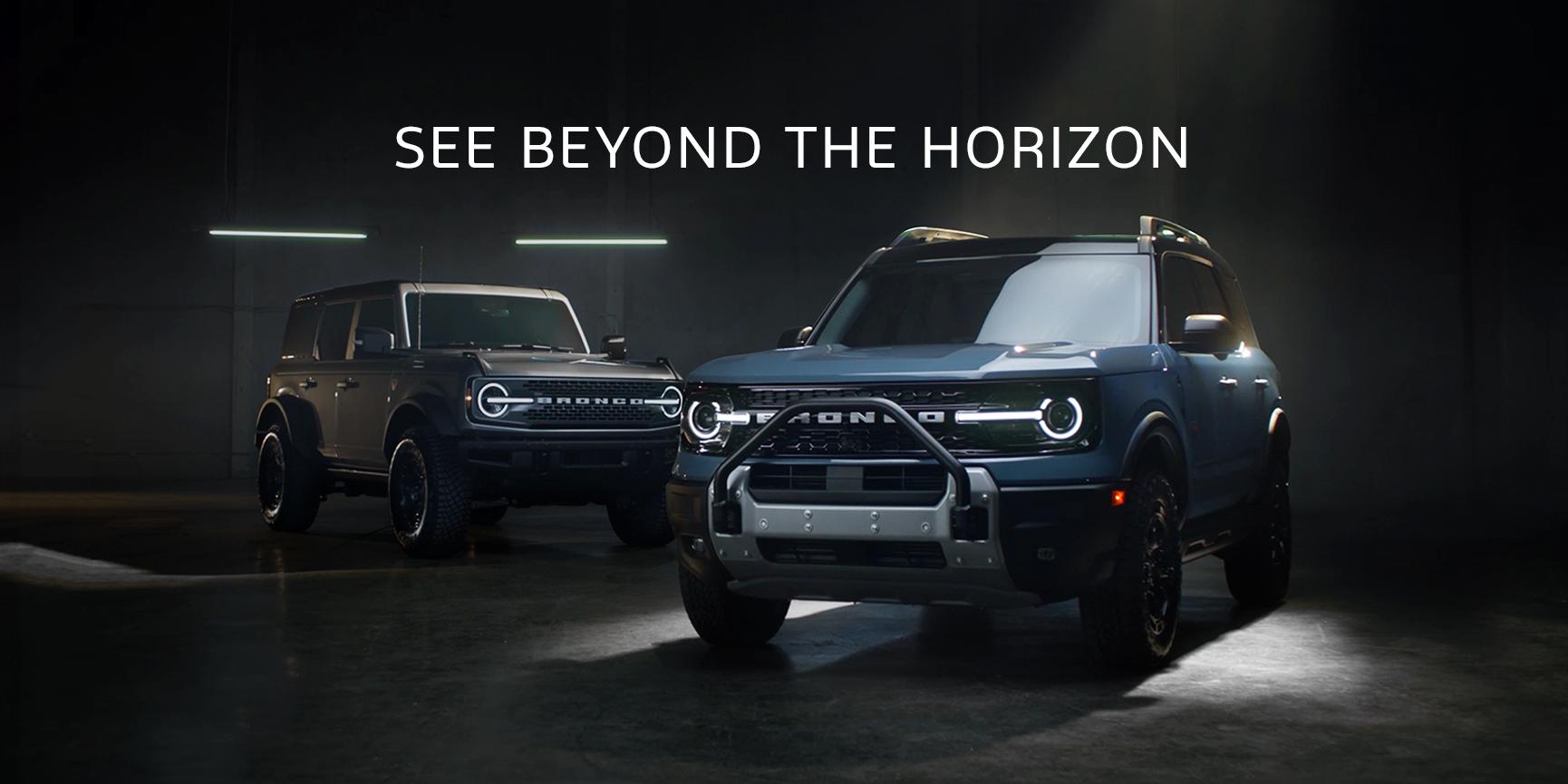 The Ford Bronco® and Bronco Sport® SUVs are shown in a dimly lit studio. Both are 2025 Badlands® models.