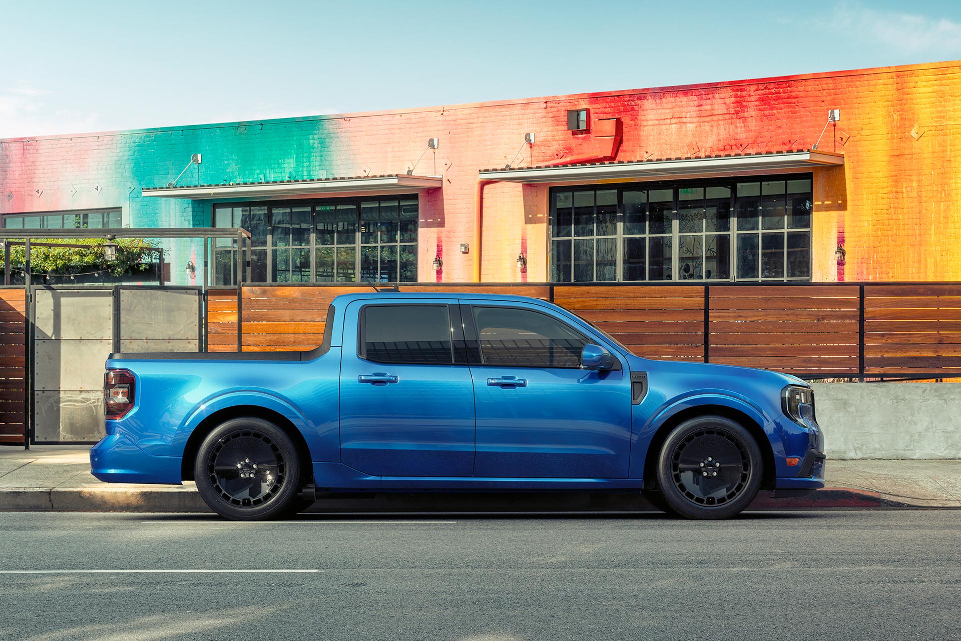 A blue 2026 Ford Maverick® Lobo™ pickup parked in front of a colorful restaurant