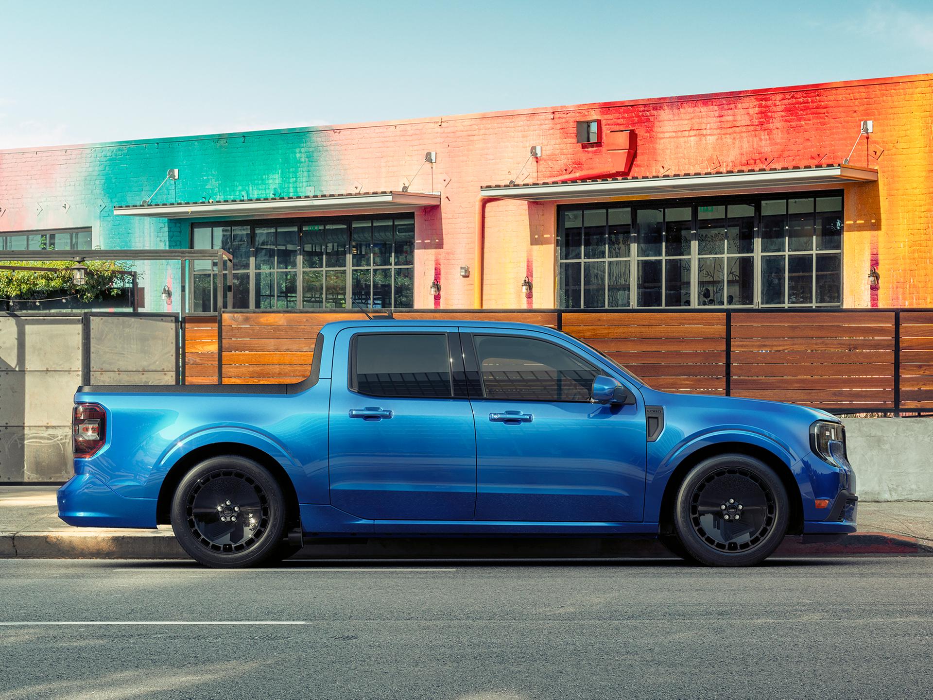 A blue 2026 Ford Maverick® Lobo™ pickup parked in front of a colorful restaurant