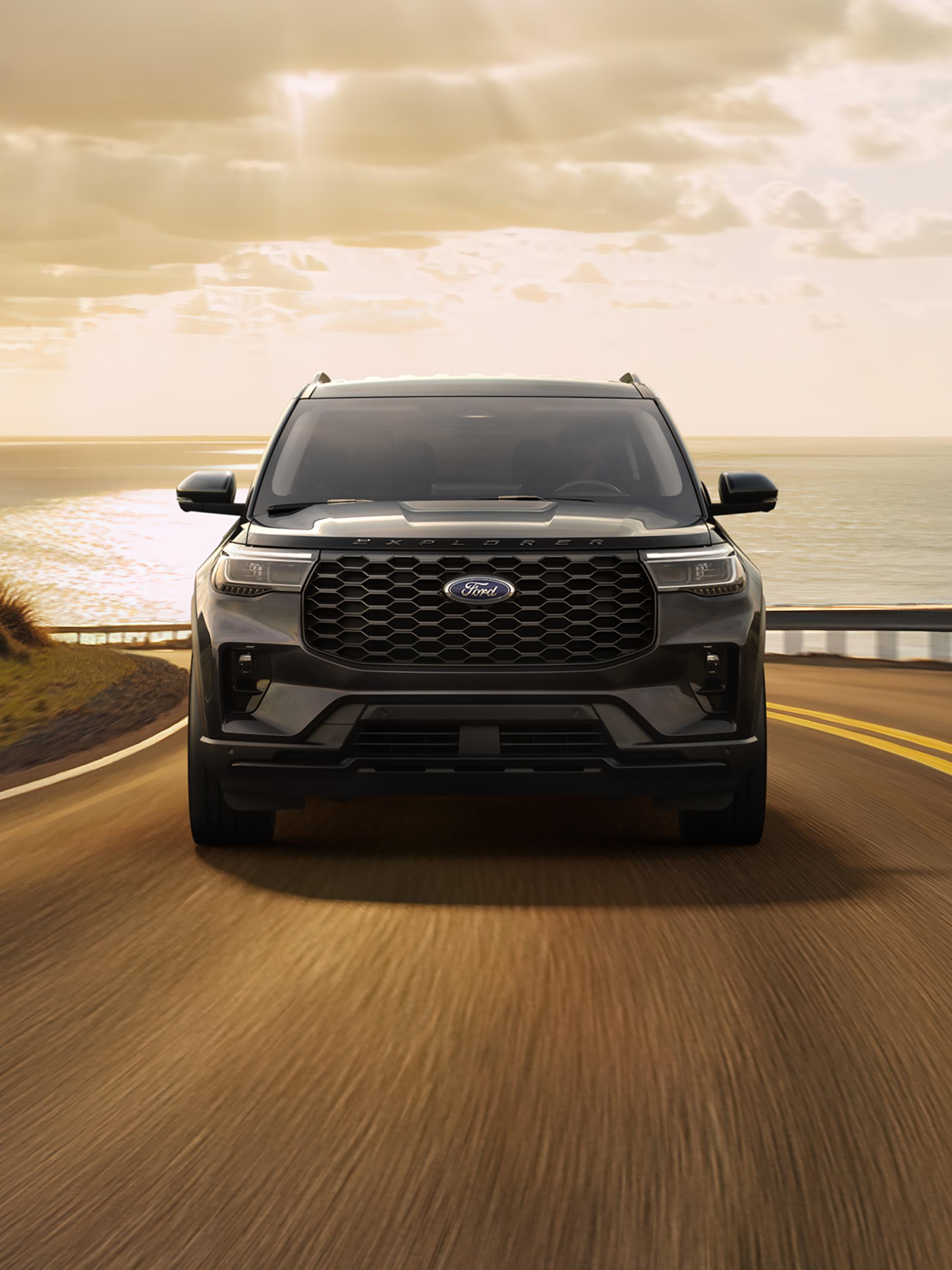 2026 Ford Explorer® model being driven on a seaside highway