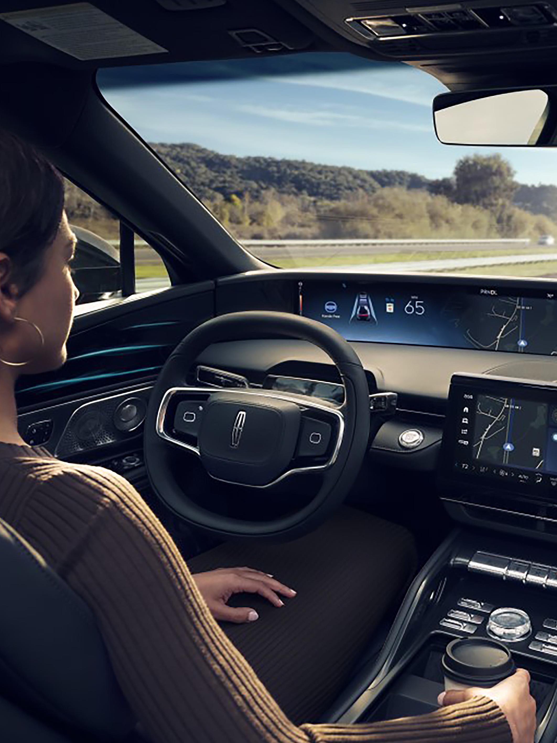 A driver of a Lincoln SUV enjoys hands-free highway driving courtesy of Lincoln BlueCruise