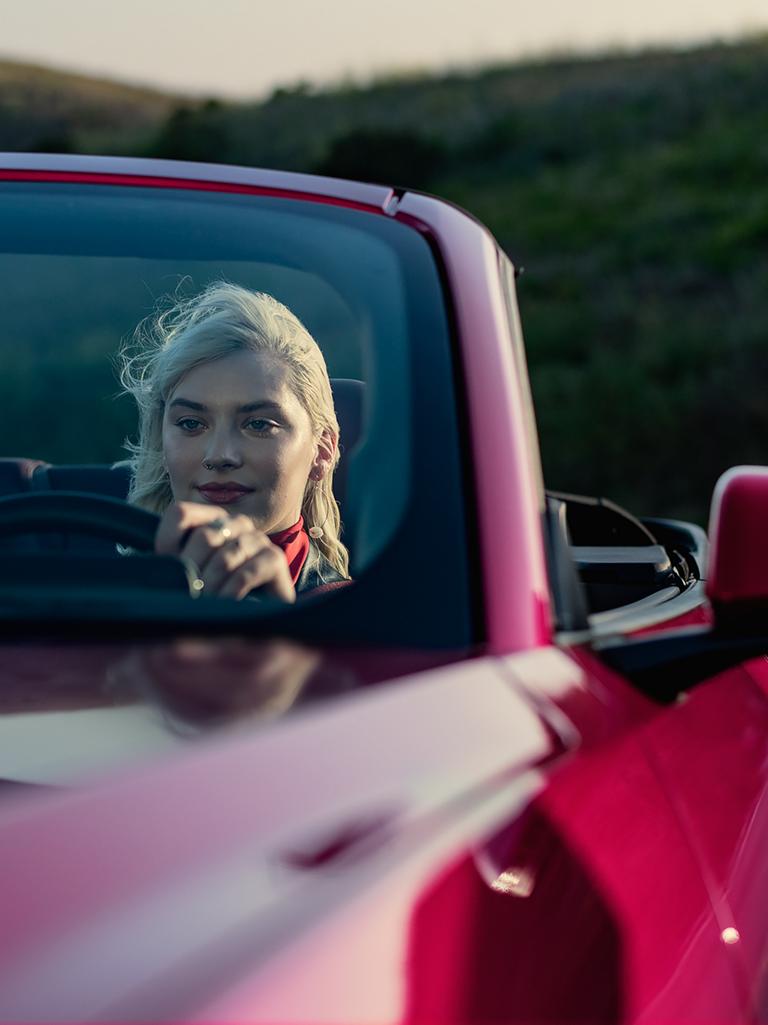 Person driving a 2025 Ford Mustang® GT convertible on a highway