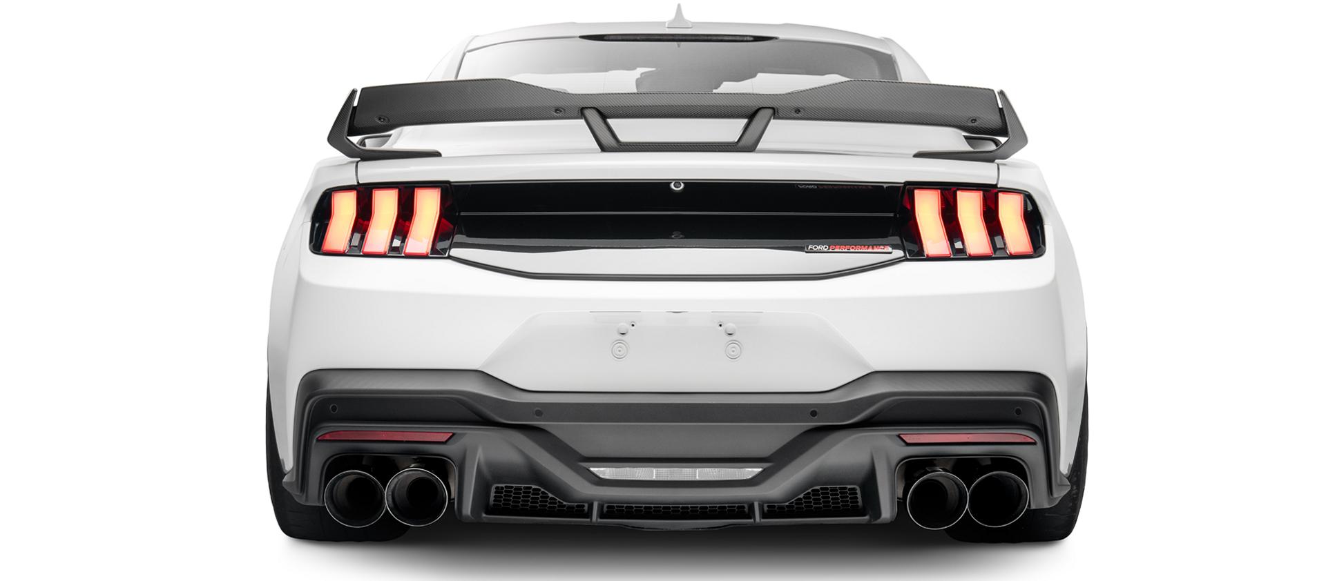 Rear view of the white Mustang showing the gloss black trunk appliqué, quad exhaust and rear diffuser