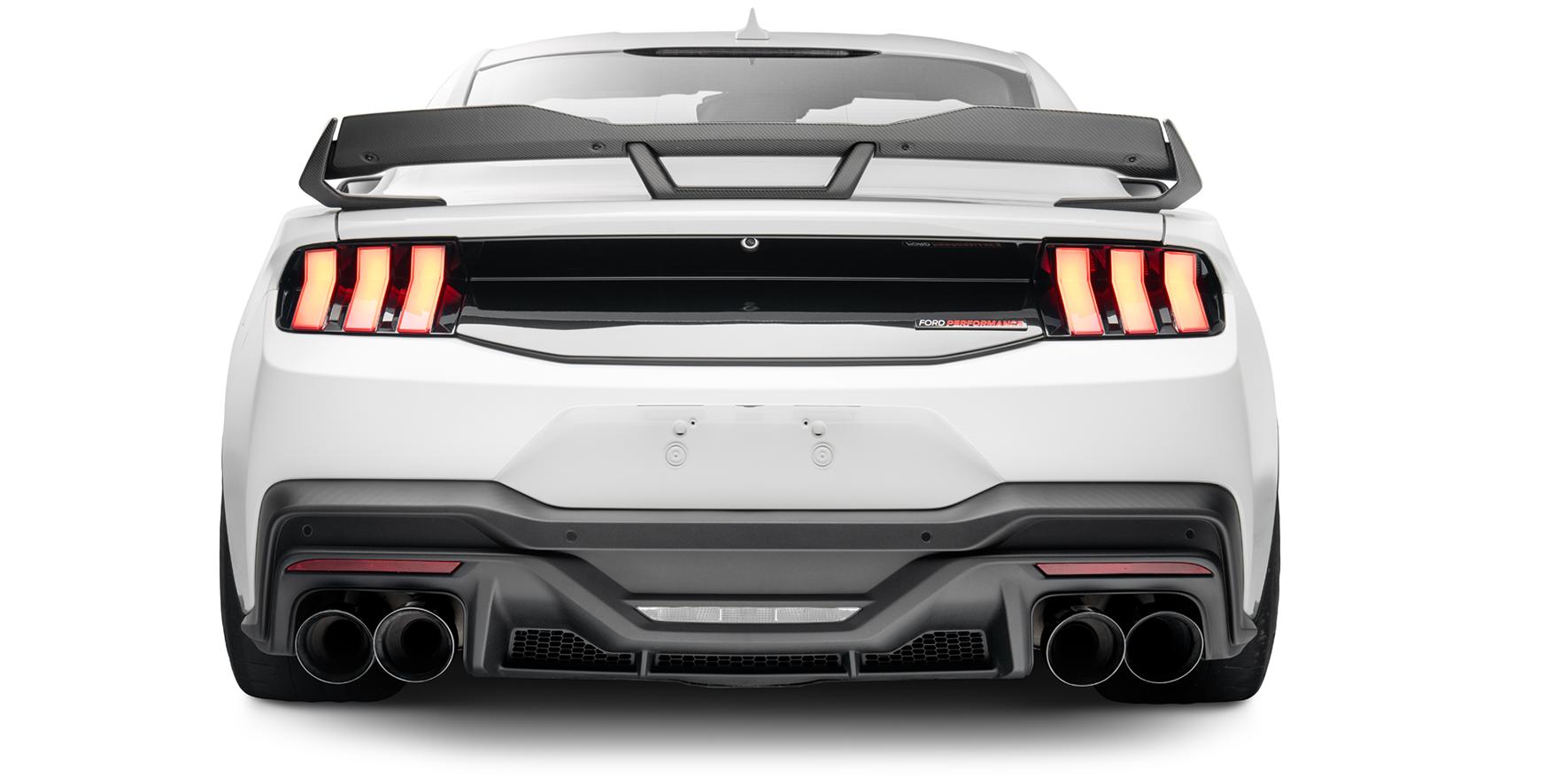 Rear view of the white Mustang showing the gloss black trunk appliqué, rear diffuser and quad exhaust