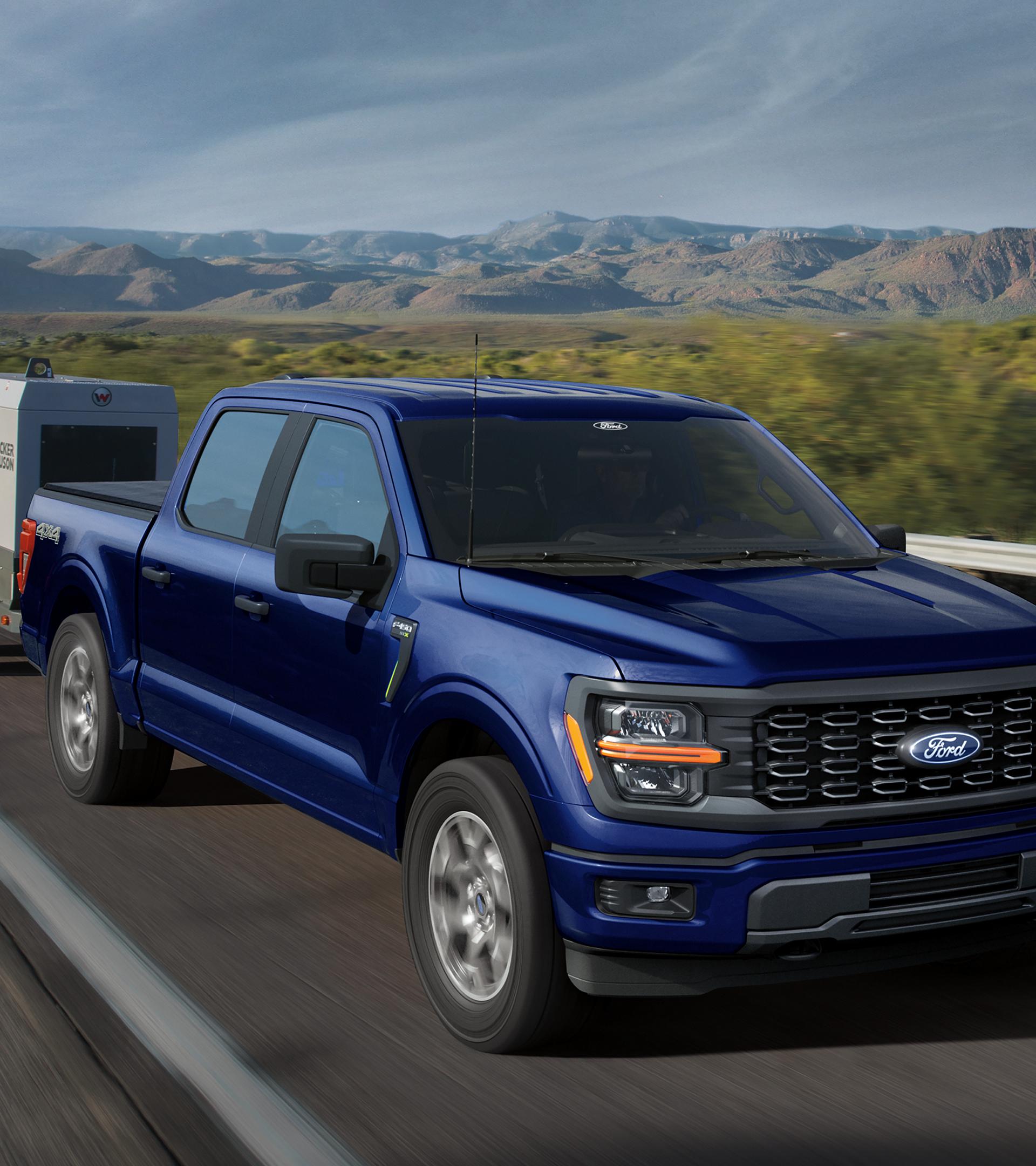 2026 Ford F-150® pickup being driven down a road in the mountains