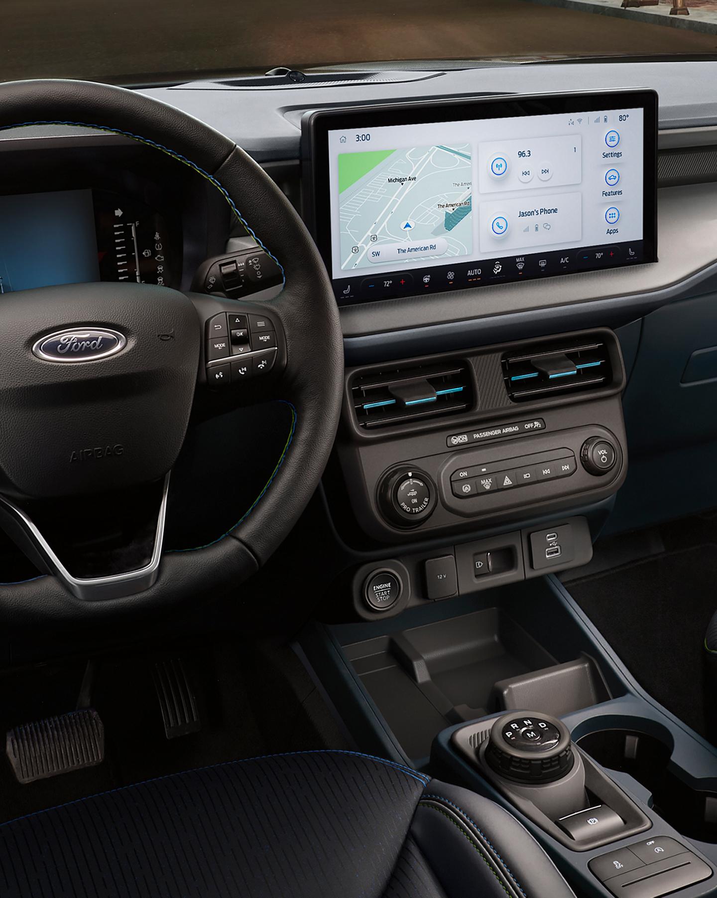 Interior view of the front passenger area showing the Steering wheel, center display and center stack controls