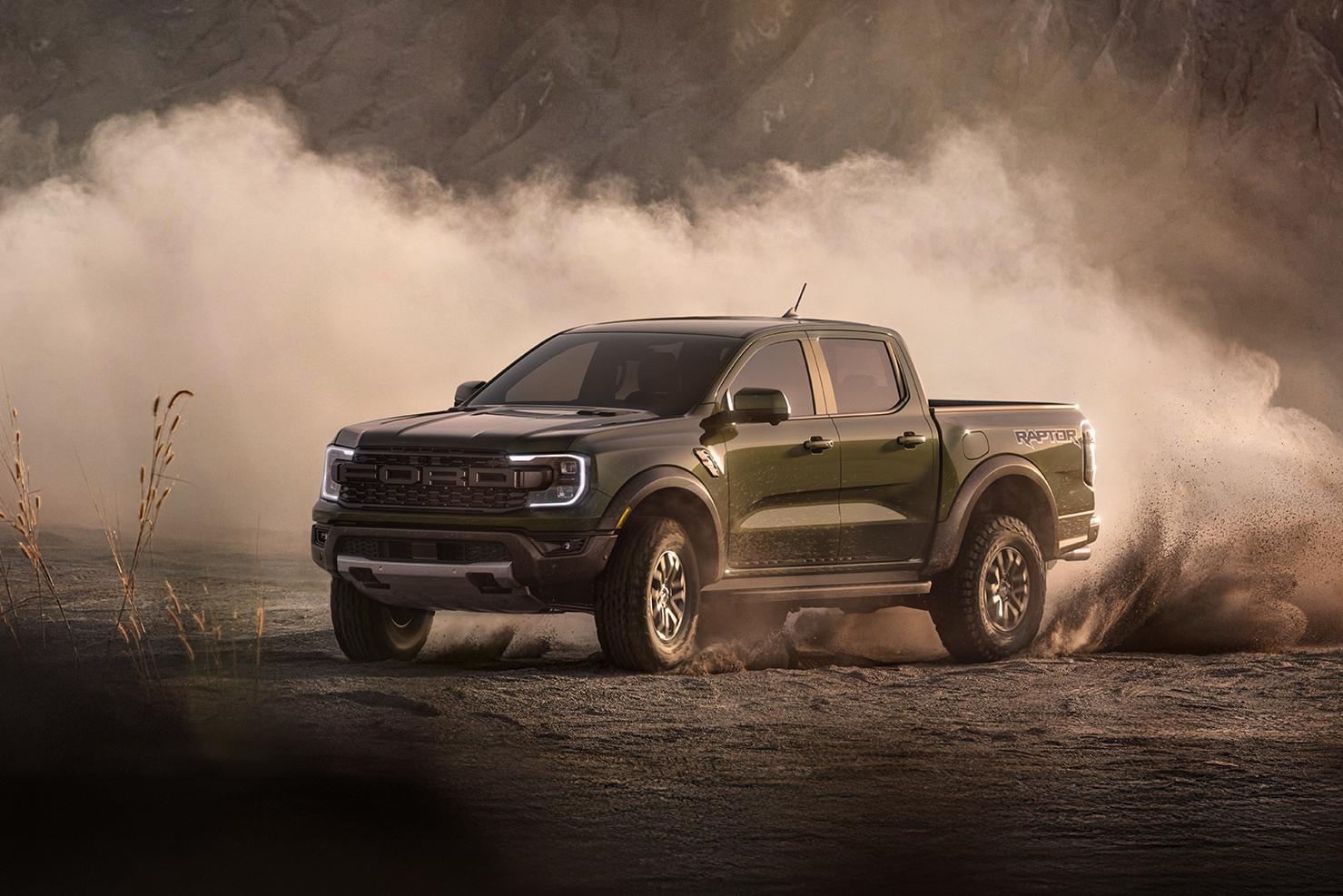 A gray 2026 Ford Ranger® Raptor® drifting through a dusty, off-road environment