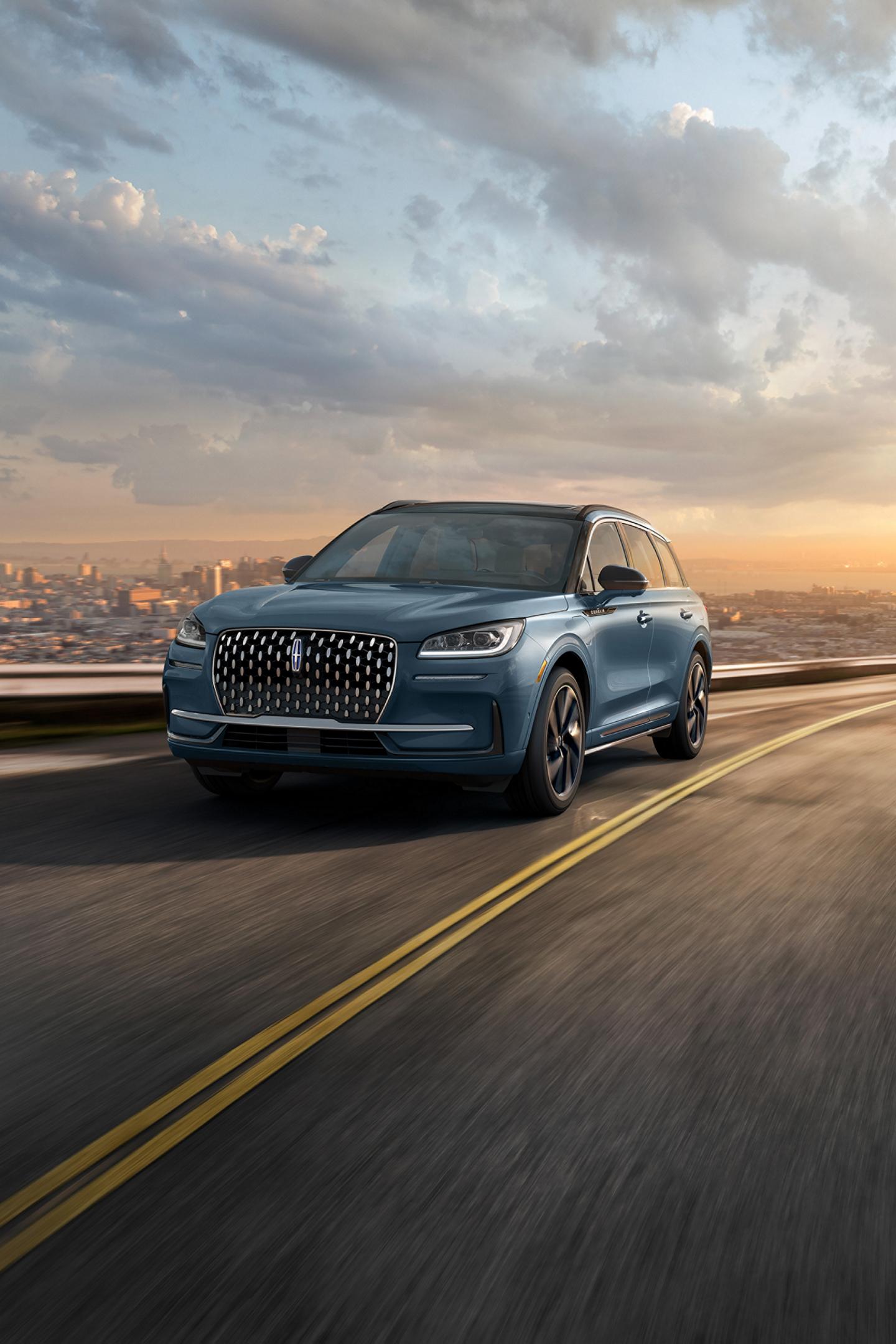 2026 Lincoln Corsair® Reserve model in the Whisper Blue exterior color is driven on a country road