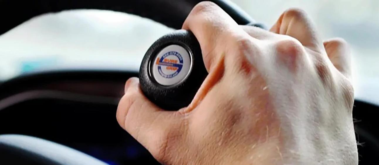 Closeup of a hand on a Ford steering device