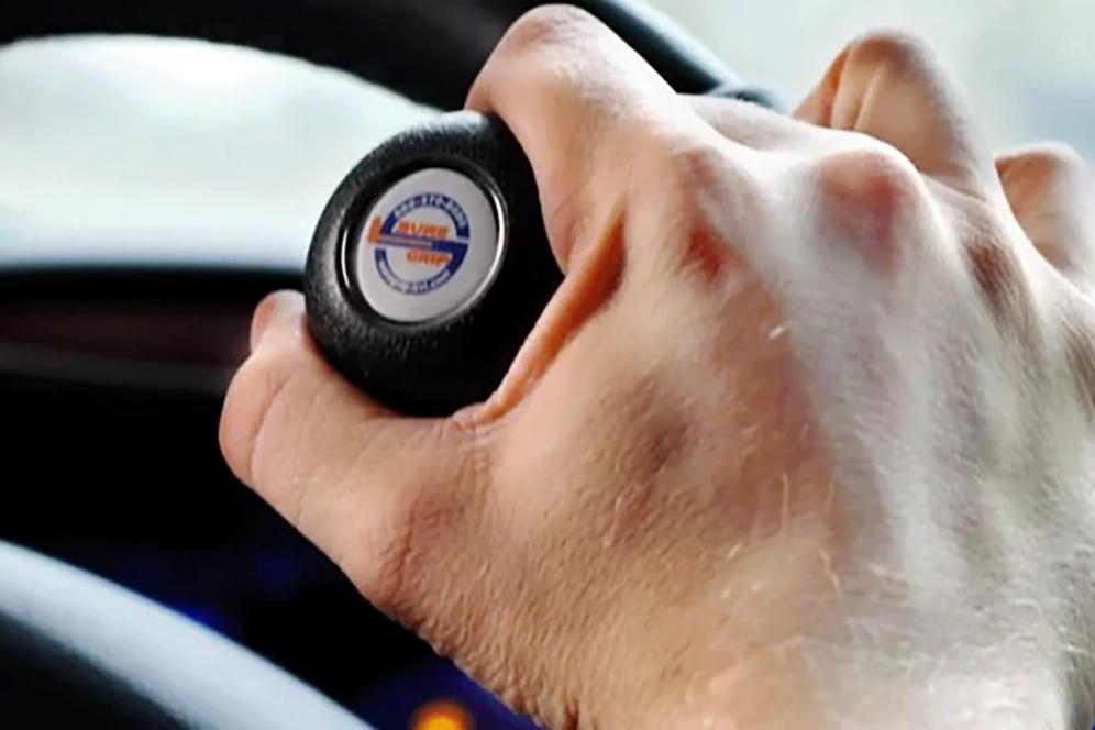 Closeup of hand on Ford steering device