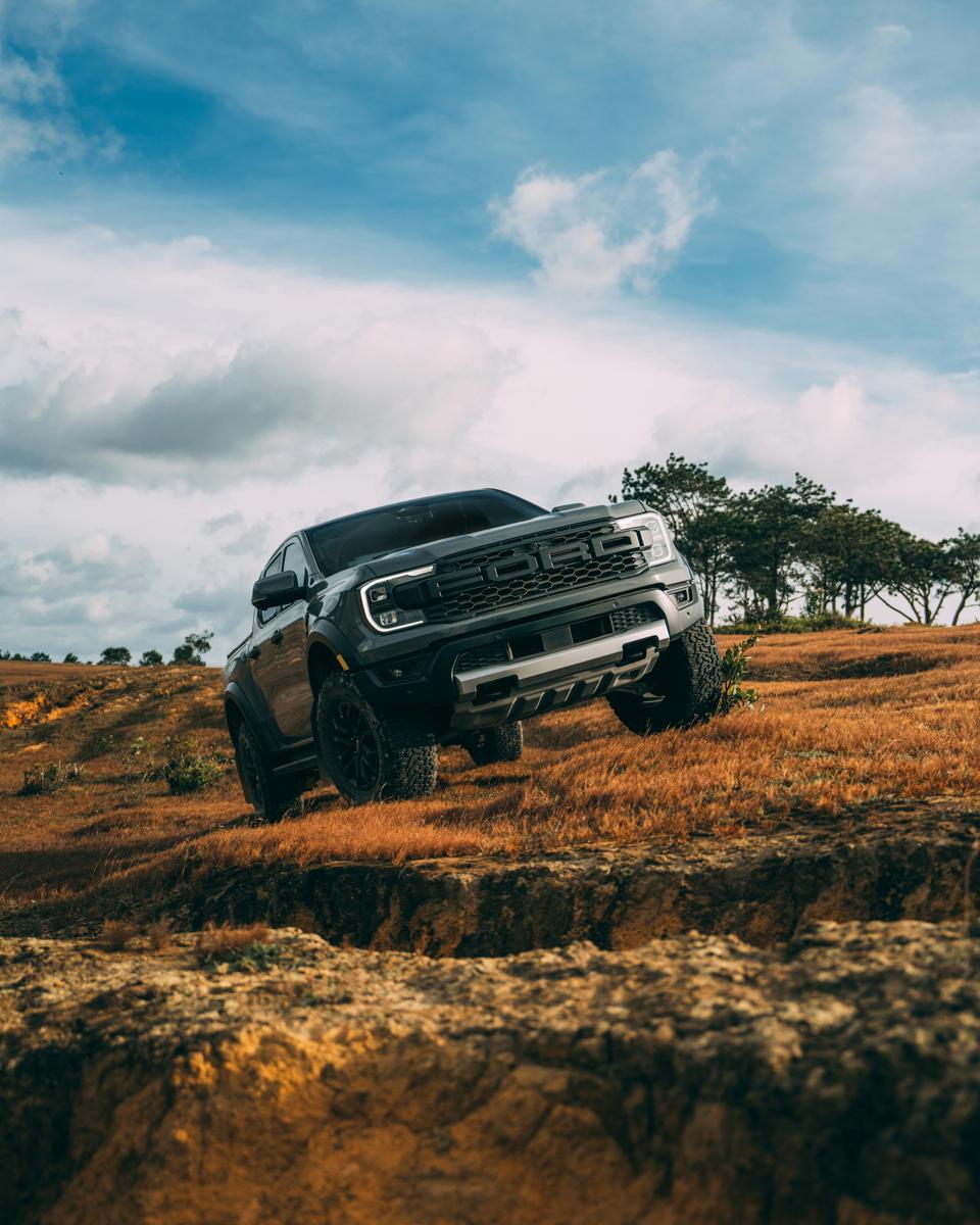 2025 Ford Ranger® Raptor® truck driving off-road driving on an uneven, grassy terrain