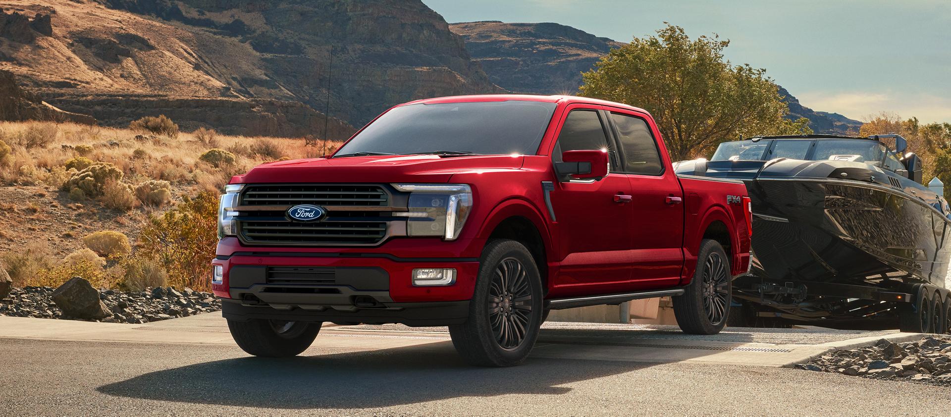 2027 Ford F-150® STX® FX4 pickup in Ruby Red Metallic pulling a boat out of the water