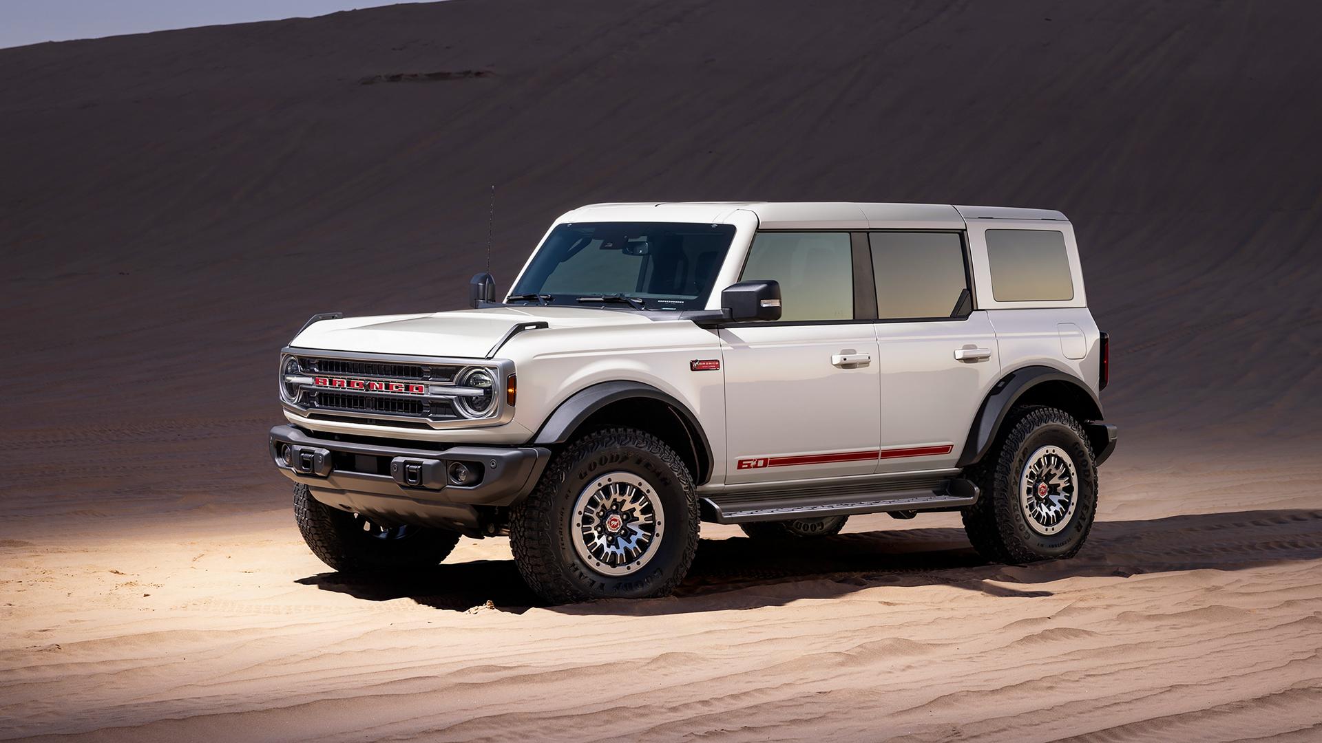 A 2026 Ford Bronco® Outer Banks® SUV with the available 60th Anniversary Package parked on a sandy expanse