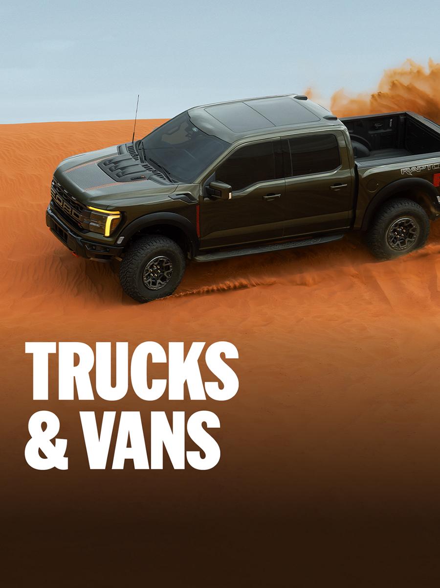 A Ford F-150® truck being driven over a sand dune