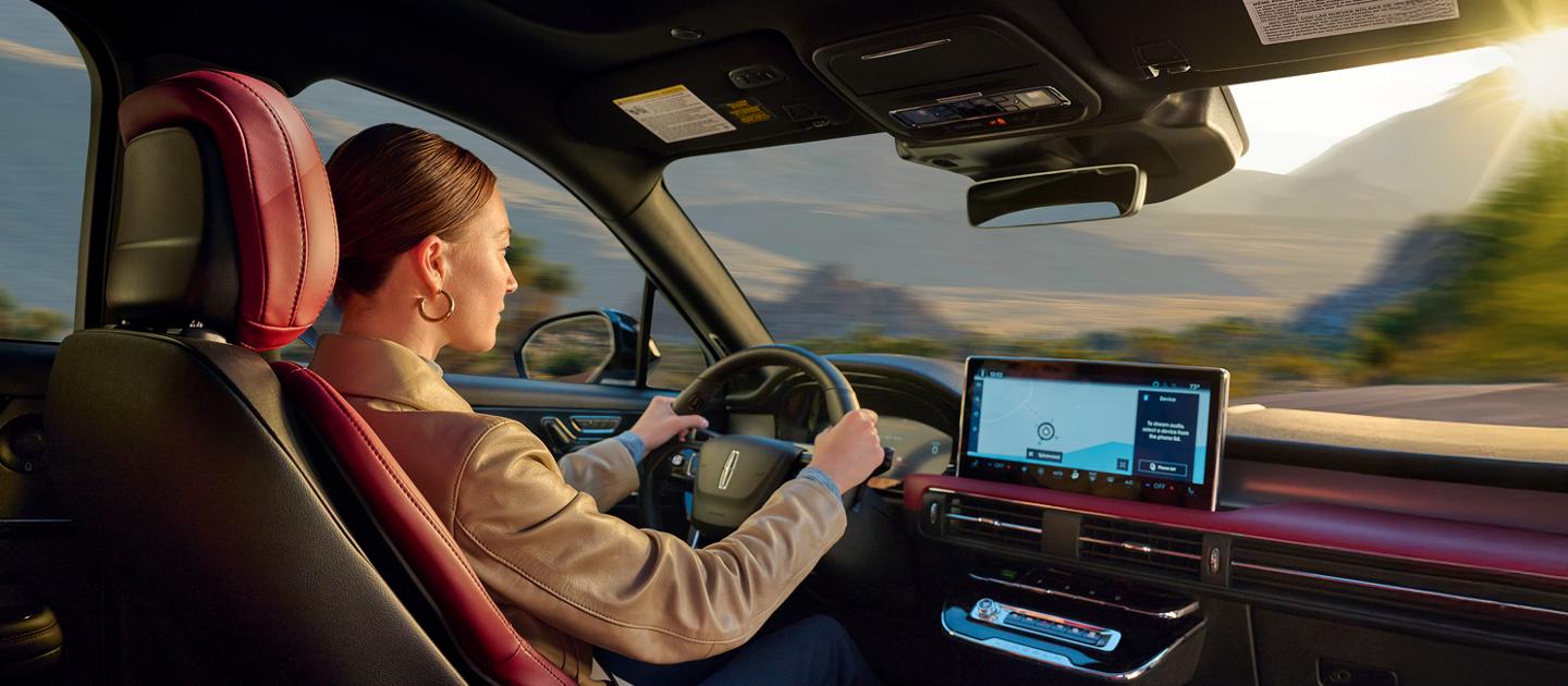 A man walking up to his Lincoln vehicle