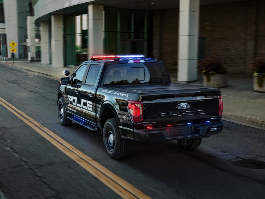 An upfitted Ford Police vehicle being driven on a city road