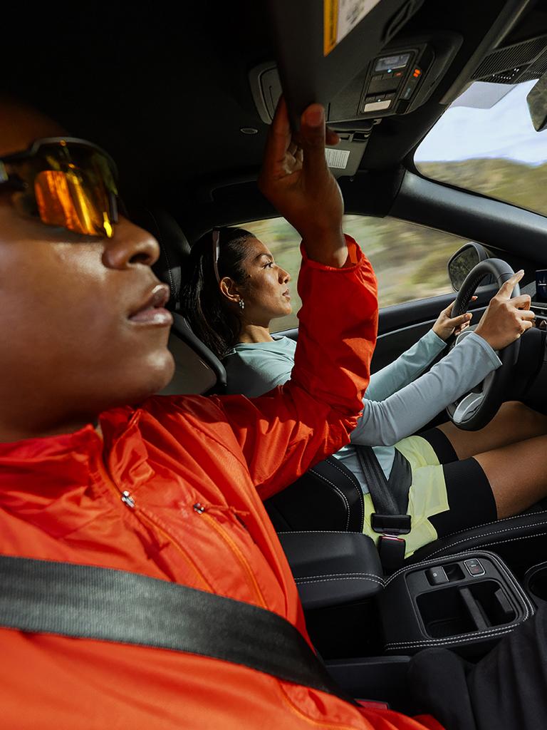 Passenger holding the grab handle in a 2026 Ford Mustang Mach-E® Rally model