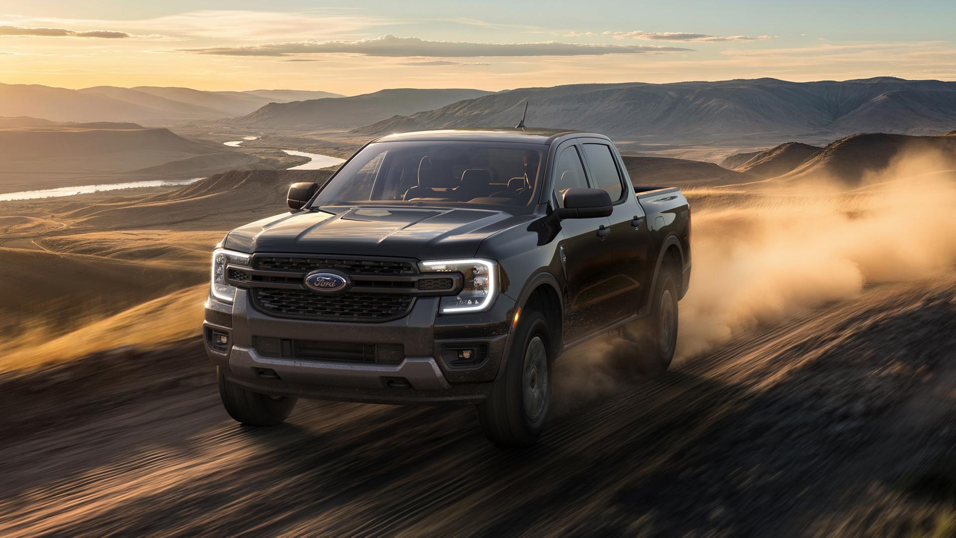 2026 Ford Ranger® XLT model with the Sport Appearance Package being driven on a desert road at dusk