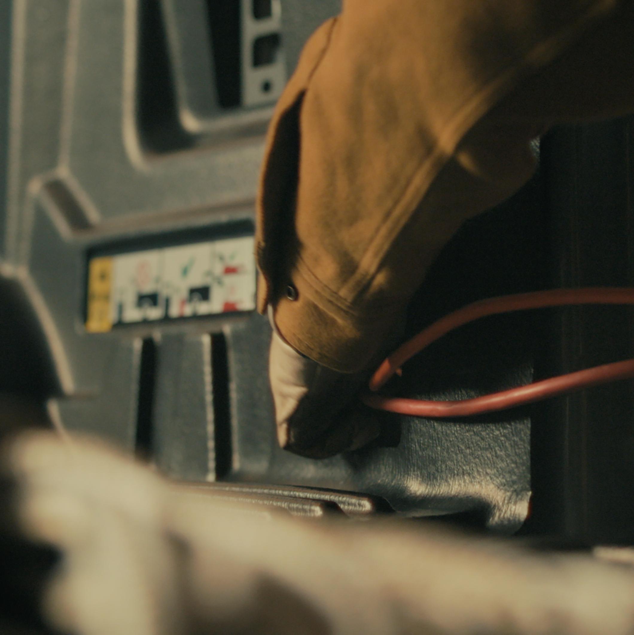 A person plugging a power tool into the Pro Power Onboard™ feature on their 2027 Ford Super Duty® XLT pickup