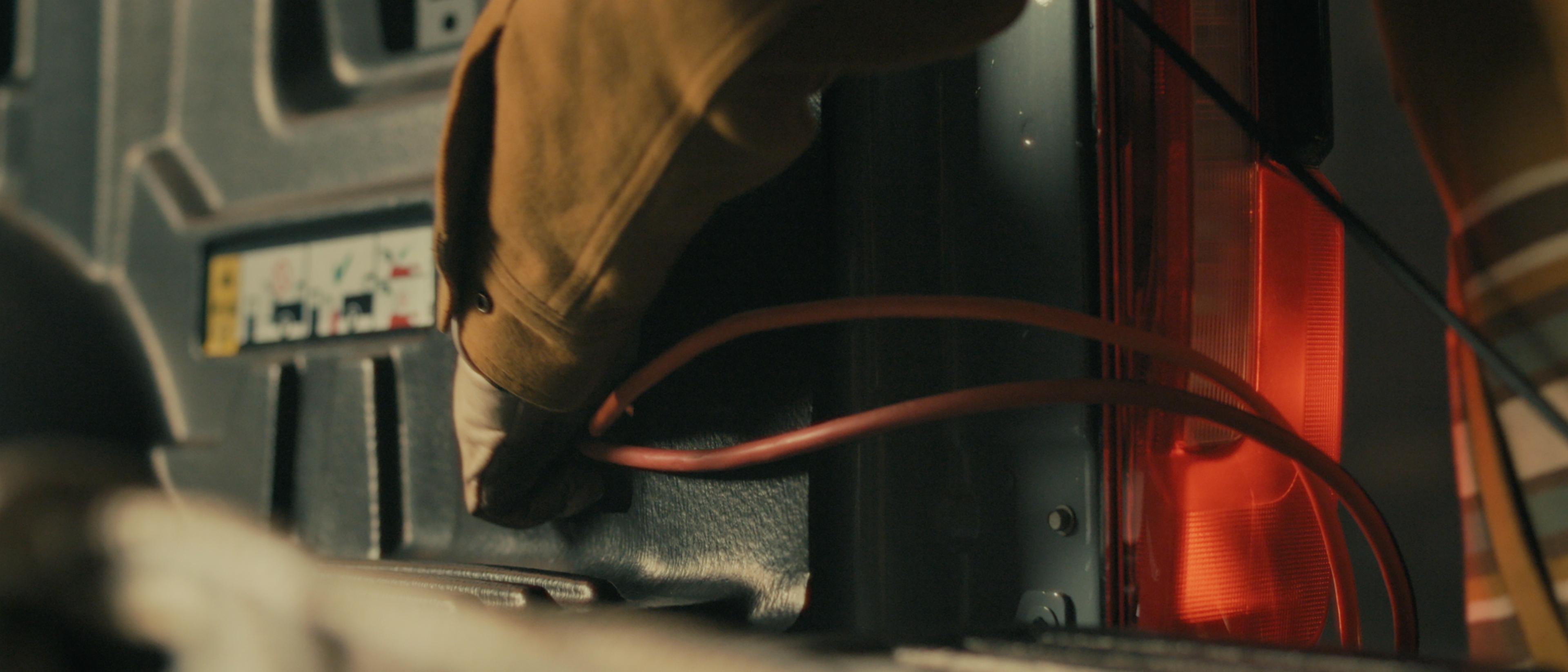 A person plugging a power tool into the Pro Power Onboard™ feature on their 2027 Ford Super Duty® XLT pickup