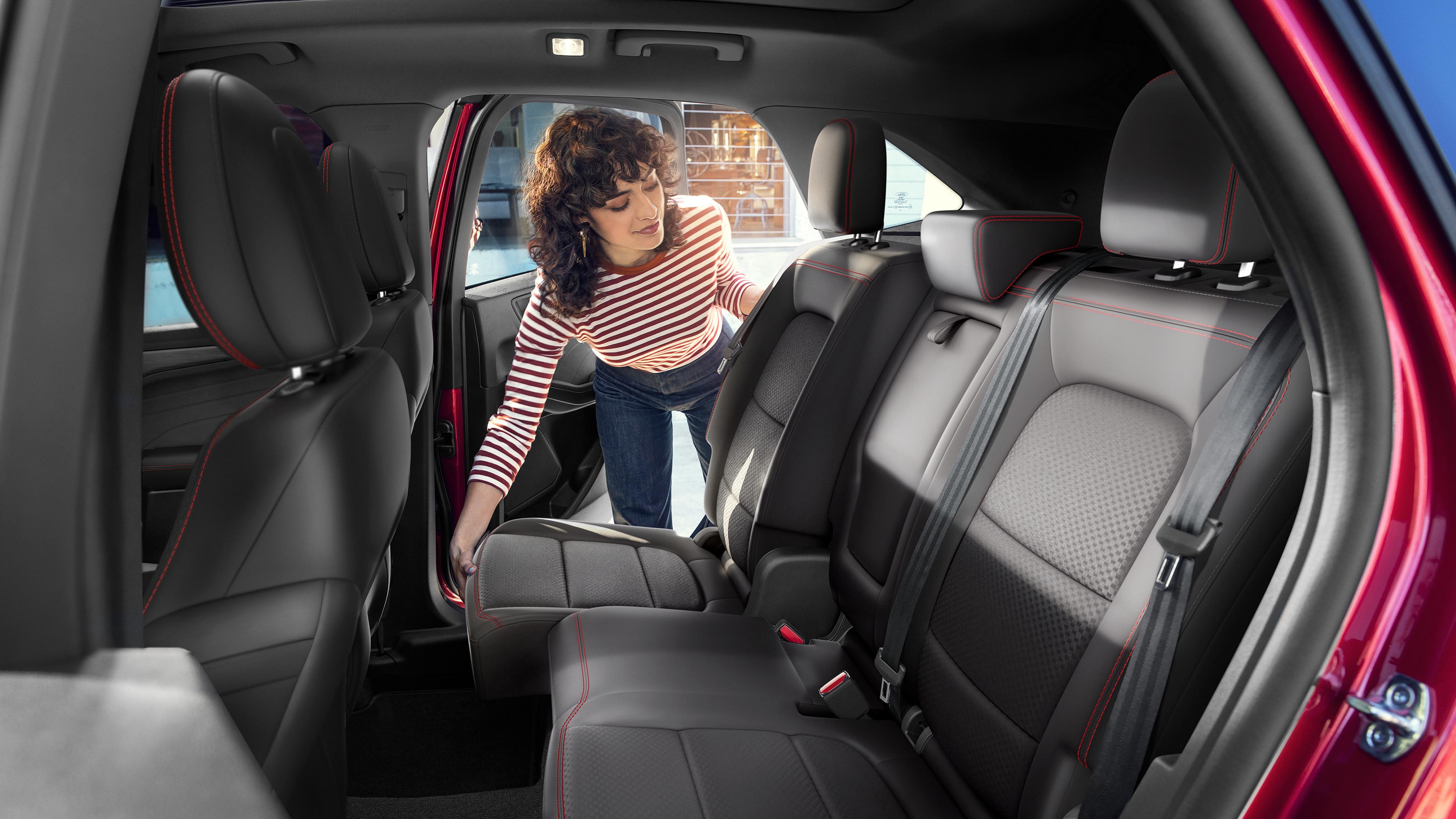 Woman adjusting the 60/40 split-fold second row in the 2026 Ford Escape® SUV