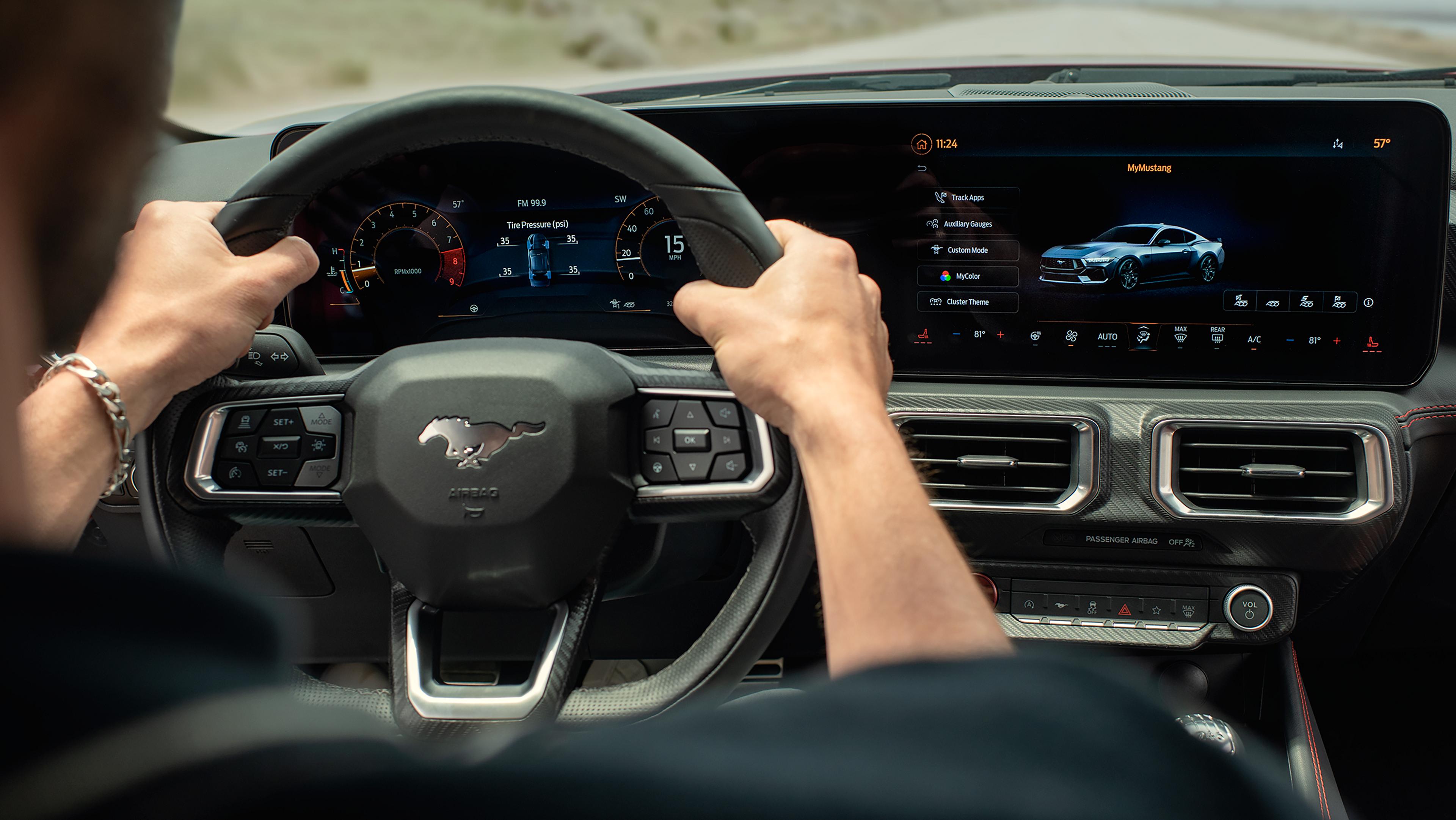 Person driving a 2026 Ford Mustang® model with the available 12.4" cluster display and 13.2" center display