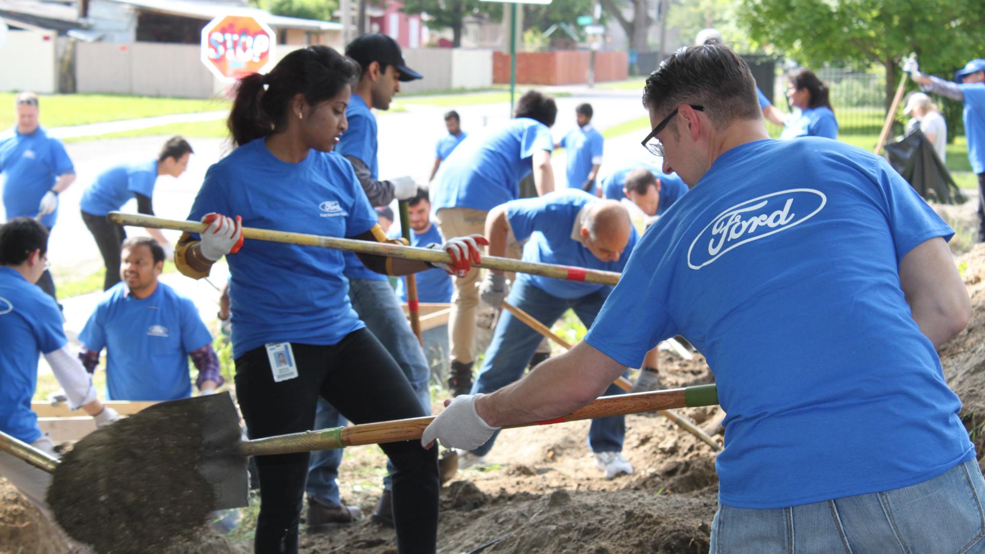 Volunteers work together in an urban garden