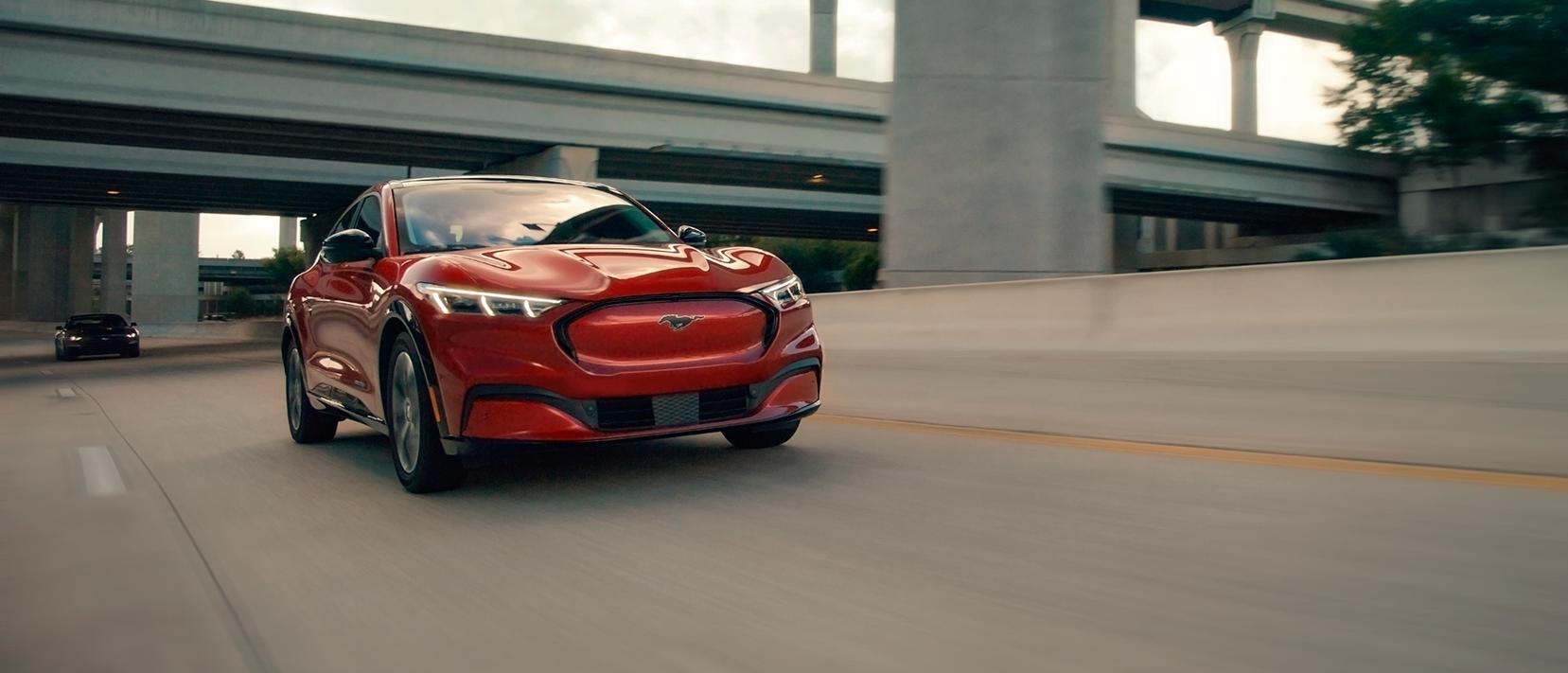 A Ford Mustang Mach-E® SUV drives down a divided highway
