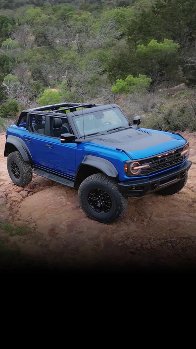 A 2026 Ford Bronco® Raptor® SUV with the available Raptor Black Appearance Package parked on a muddy landscape