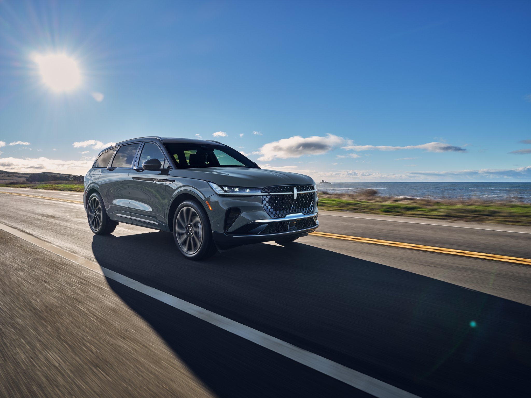 A 2025 Lincoln Black Label Nautilus® SUV is being driven on a country road
