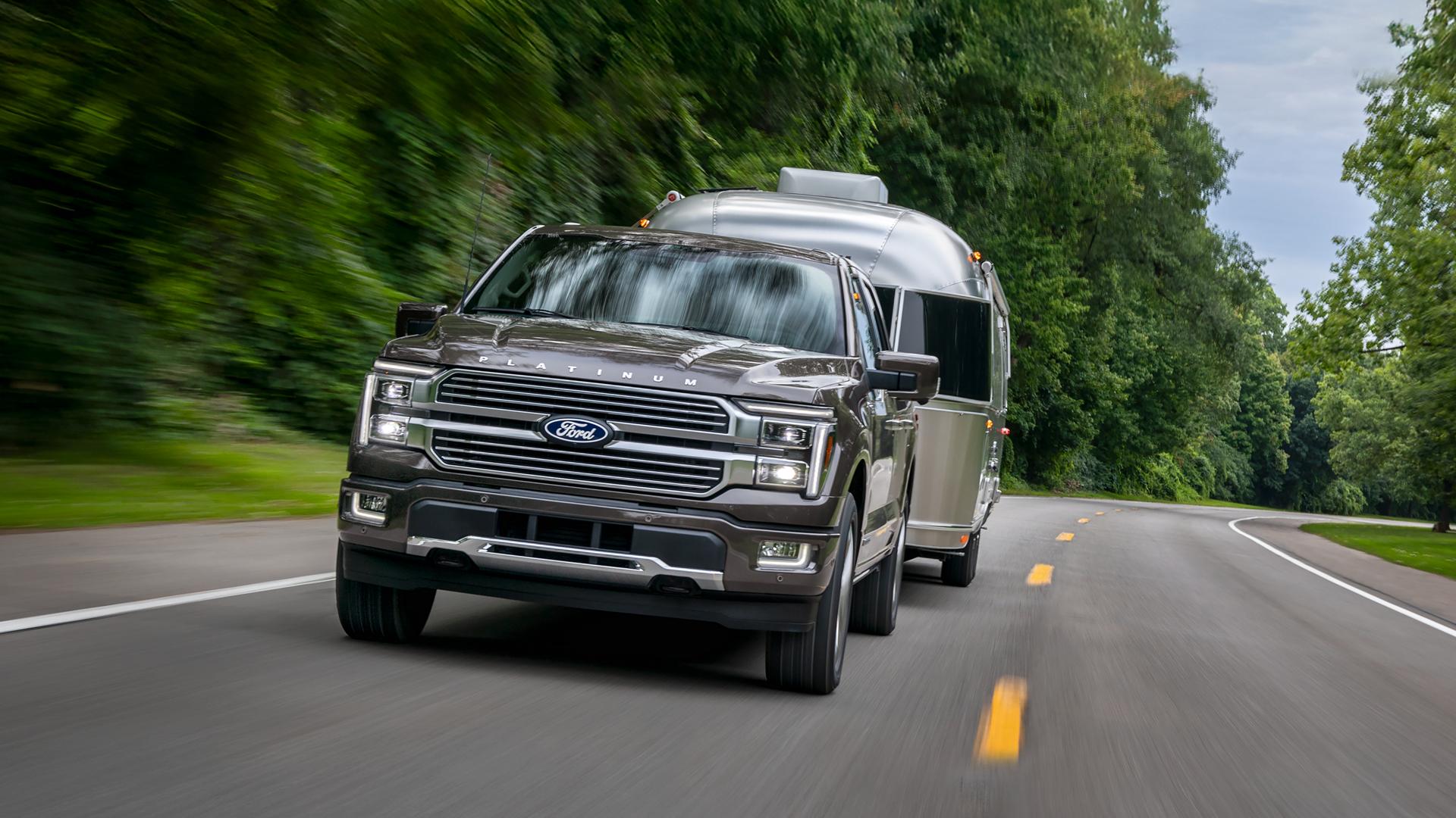 2026 Ford F-150® Platinum® truck in Marsh Gray pulling a camper