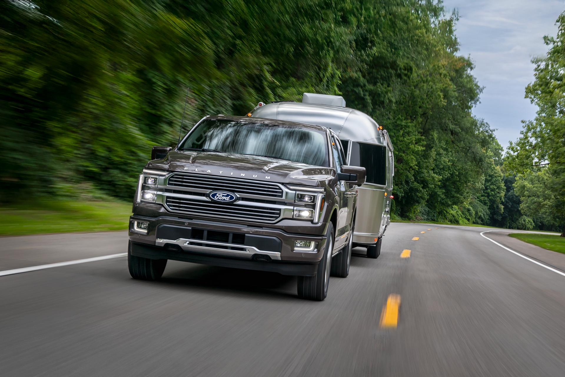 2026 Ford F-150® Platinum® truck in Marsh Gray pulling a camper