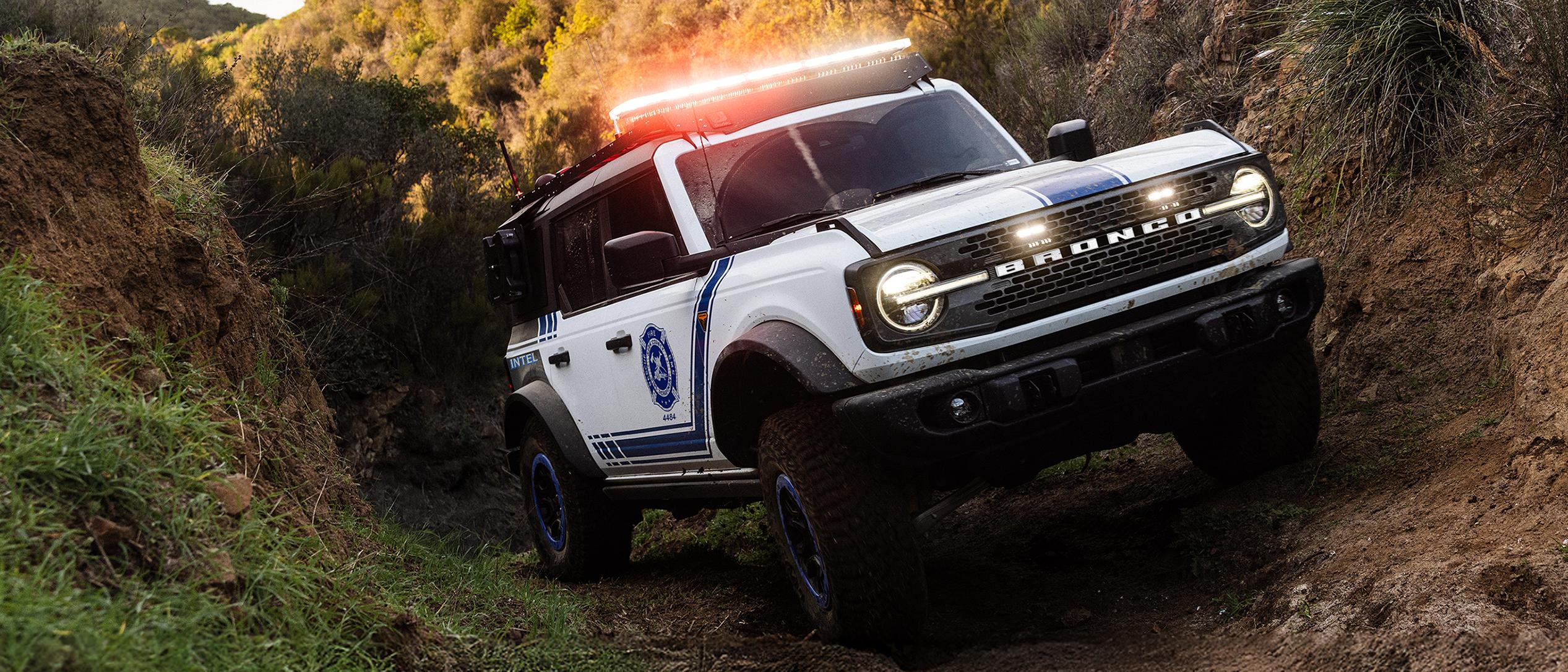 A Ford Bronco Badlands equipped with search and rescue gear driving on an incline.