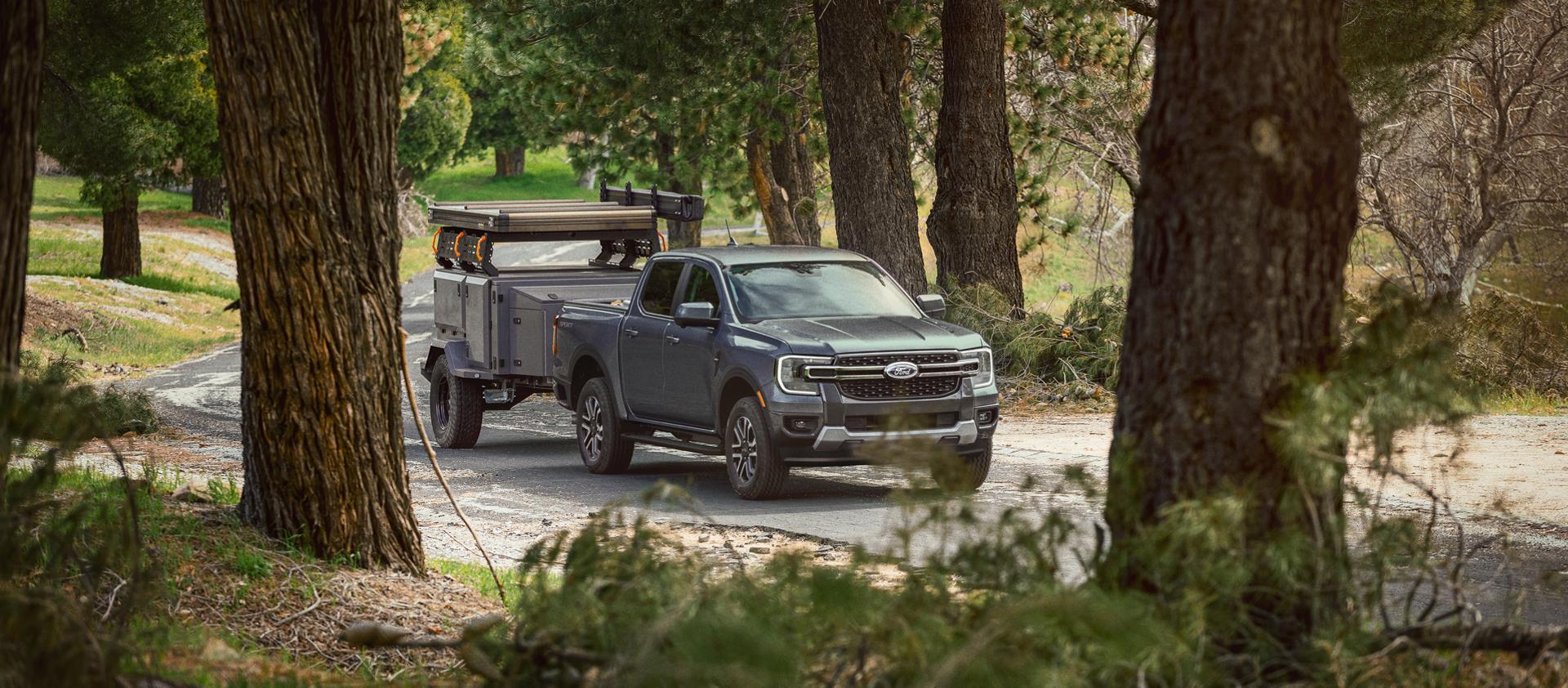 2026 Ford Ranger® truck pulling a large trailer on a paved road