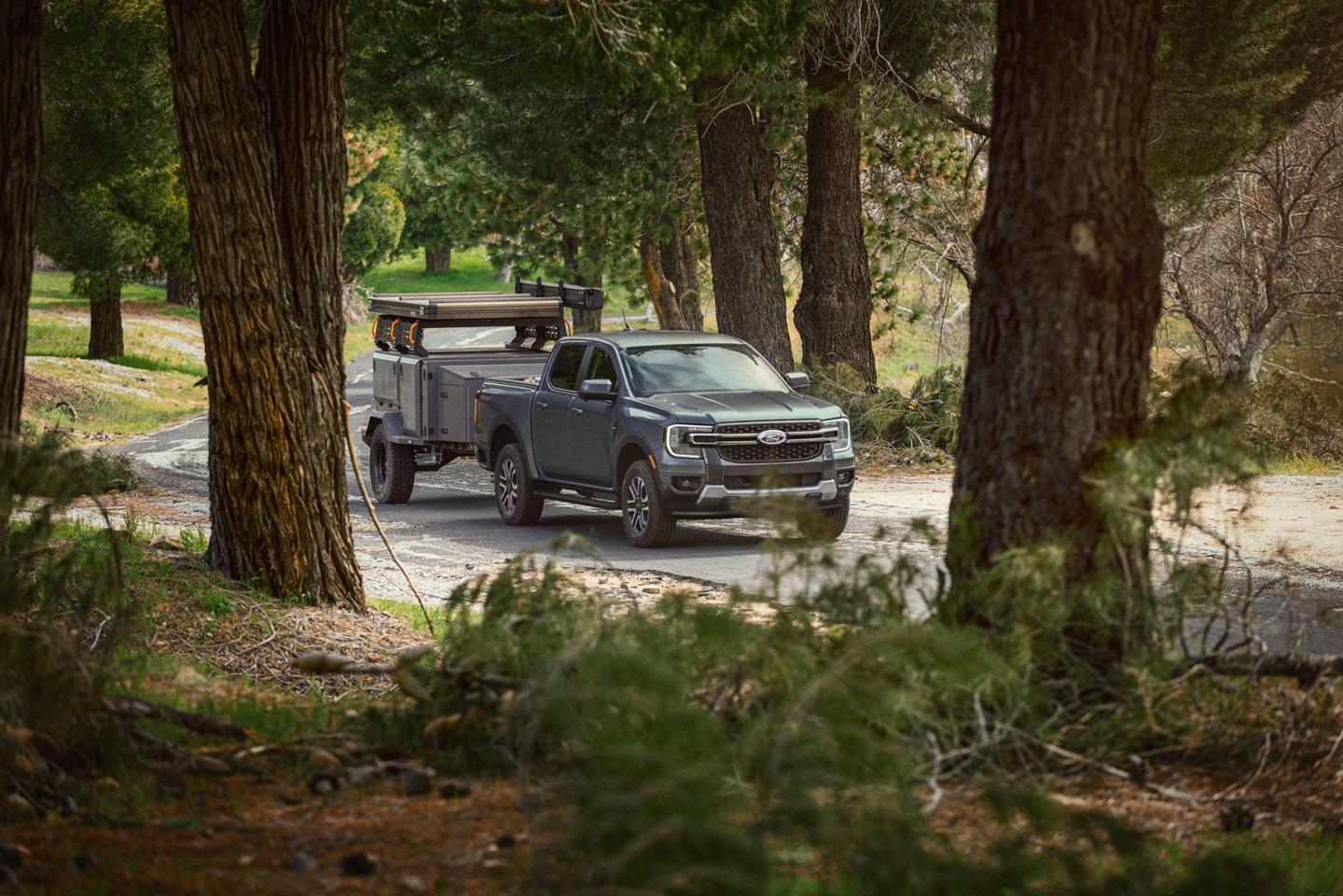 2026 Ford Ranger® truck pulling a large trailer on a paved road