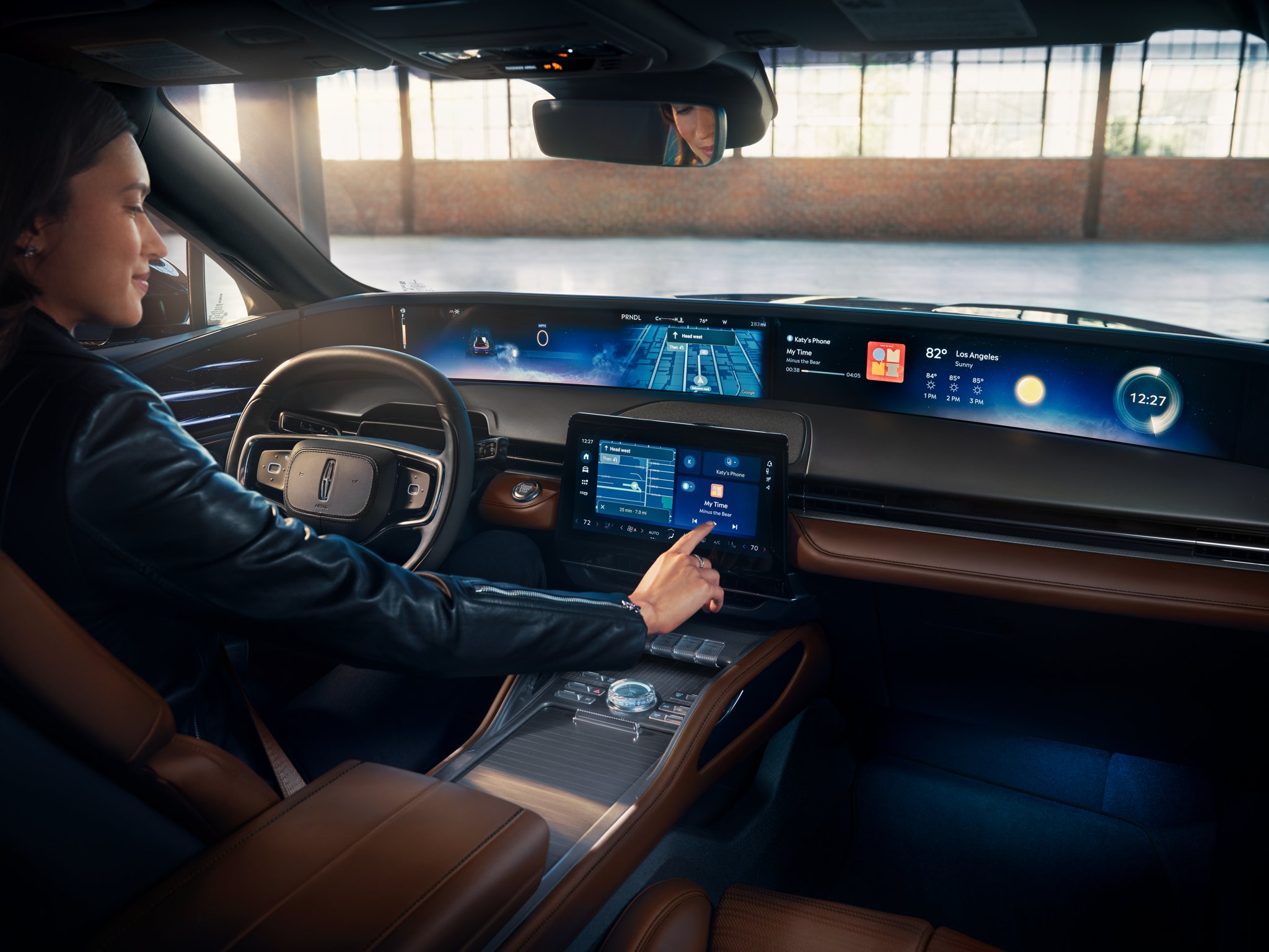 A woman interacts with the centre touchscreen of a 2026 Lincoln Nautilus
