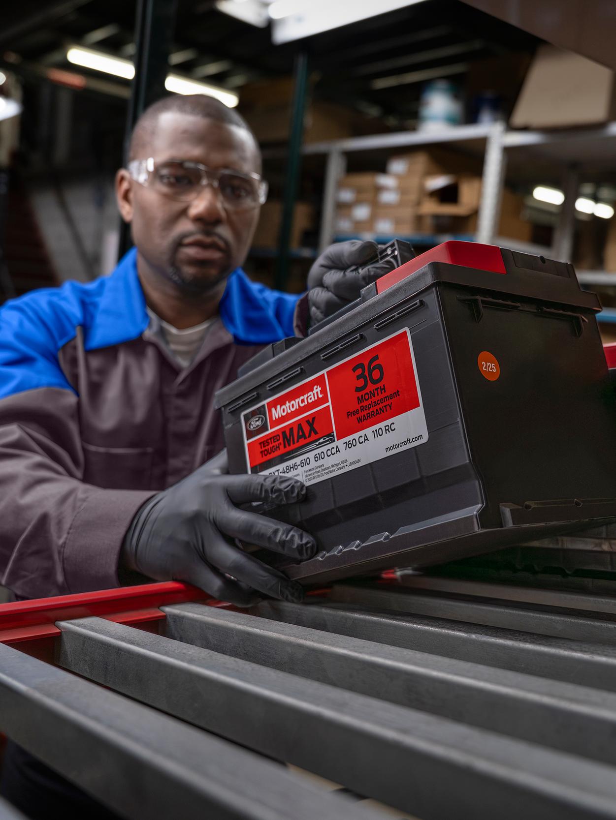A Ford Service technician replaces a battery