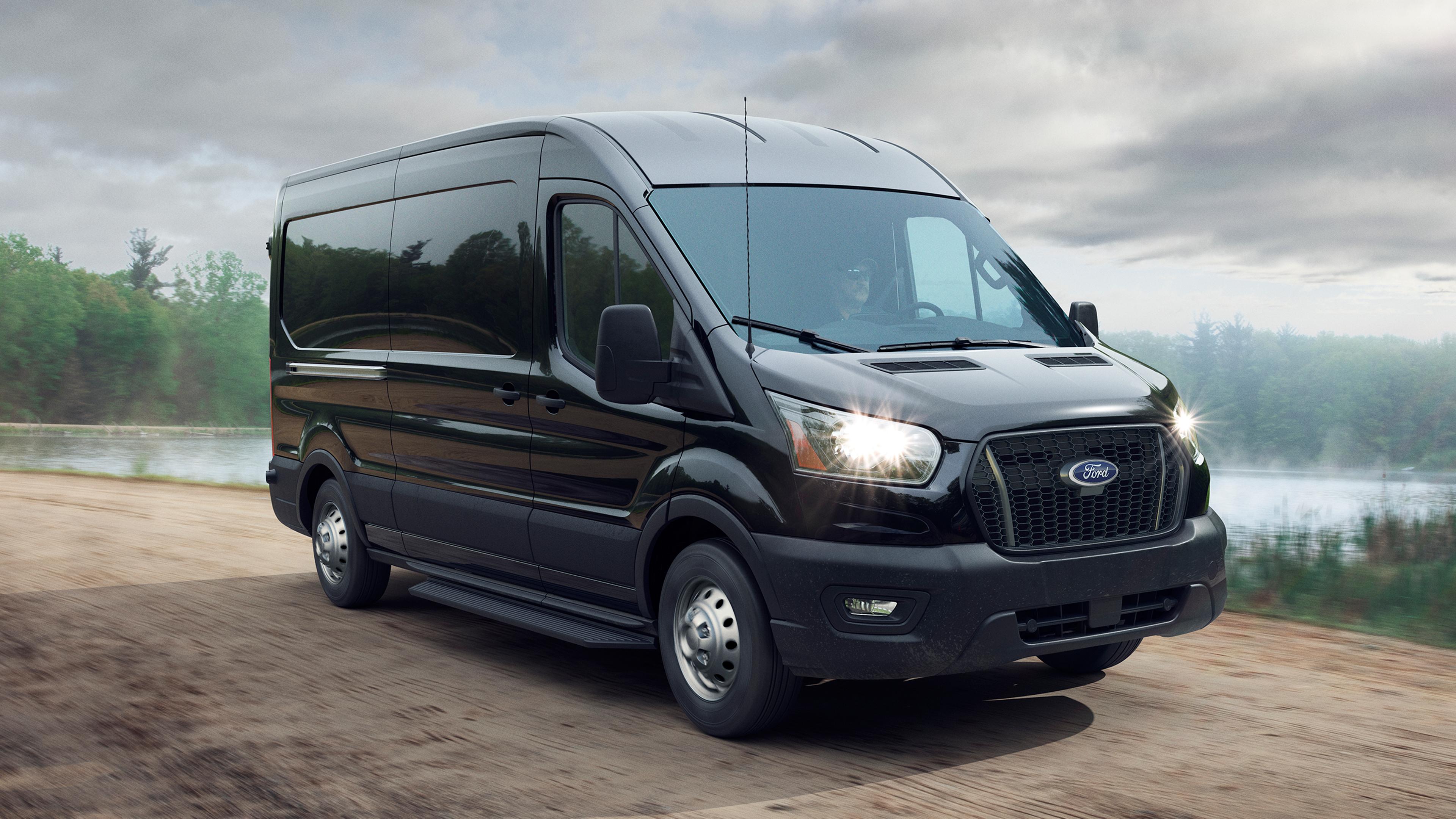 A 2026 Ford Transit® van driving down nature road